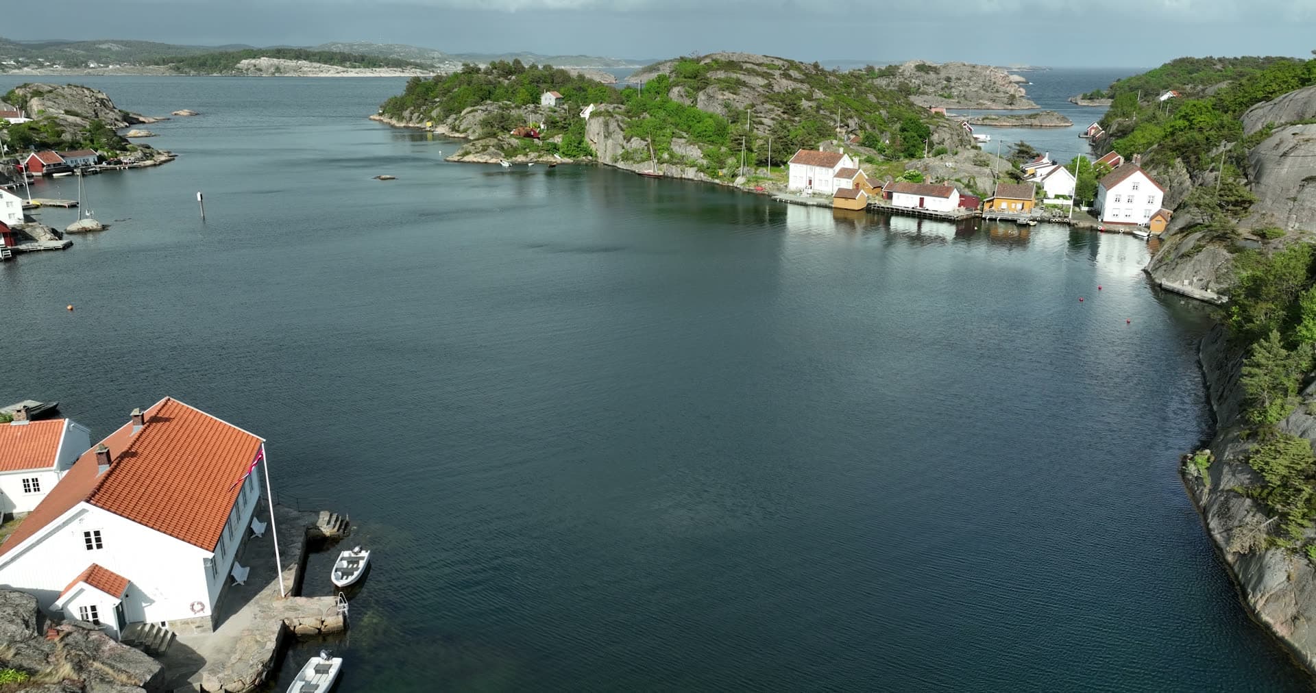 Sheltered harbor basin enclosed by steep granite walls, Ny-Hellesund, Norway