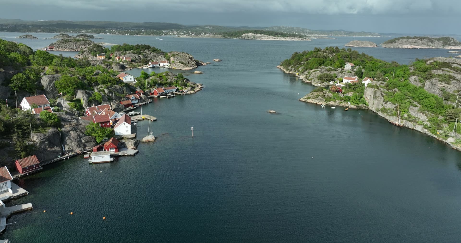 Narrow granite channel separating two forested headlands, Ny-Hellesund, Norway