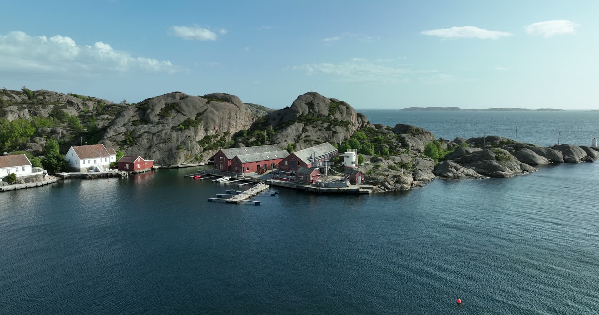 Massive granite boulders framing sheltered harbor, Ny-Hellesund, Norway