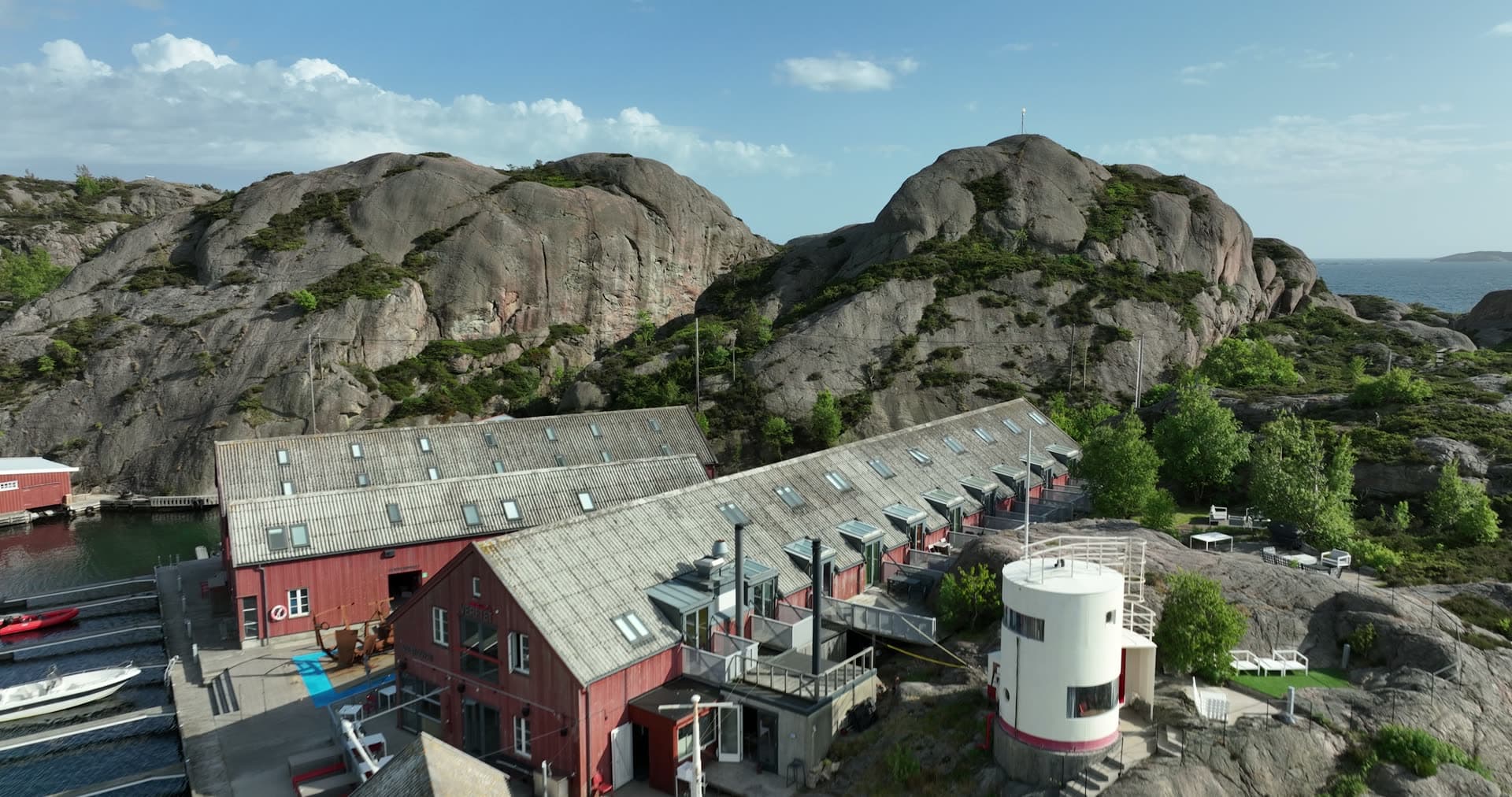 Massive granite boulders framing coastal settlement, Ny-Hellesund, Norway