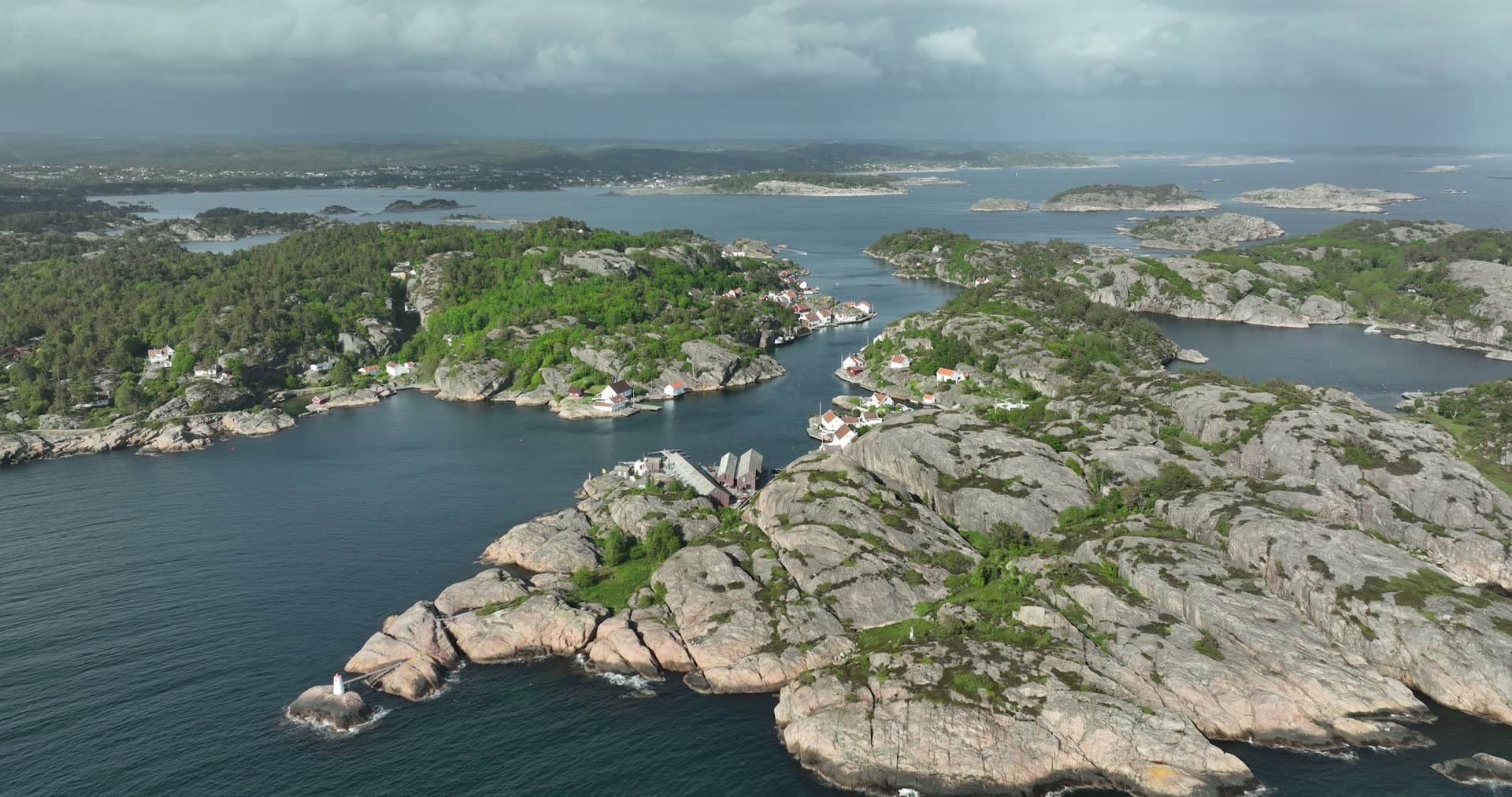 Granite foreground and scattered island settlements, Ny-Hellesund, Norway