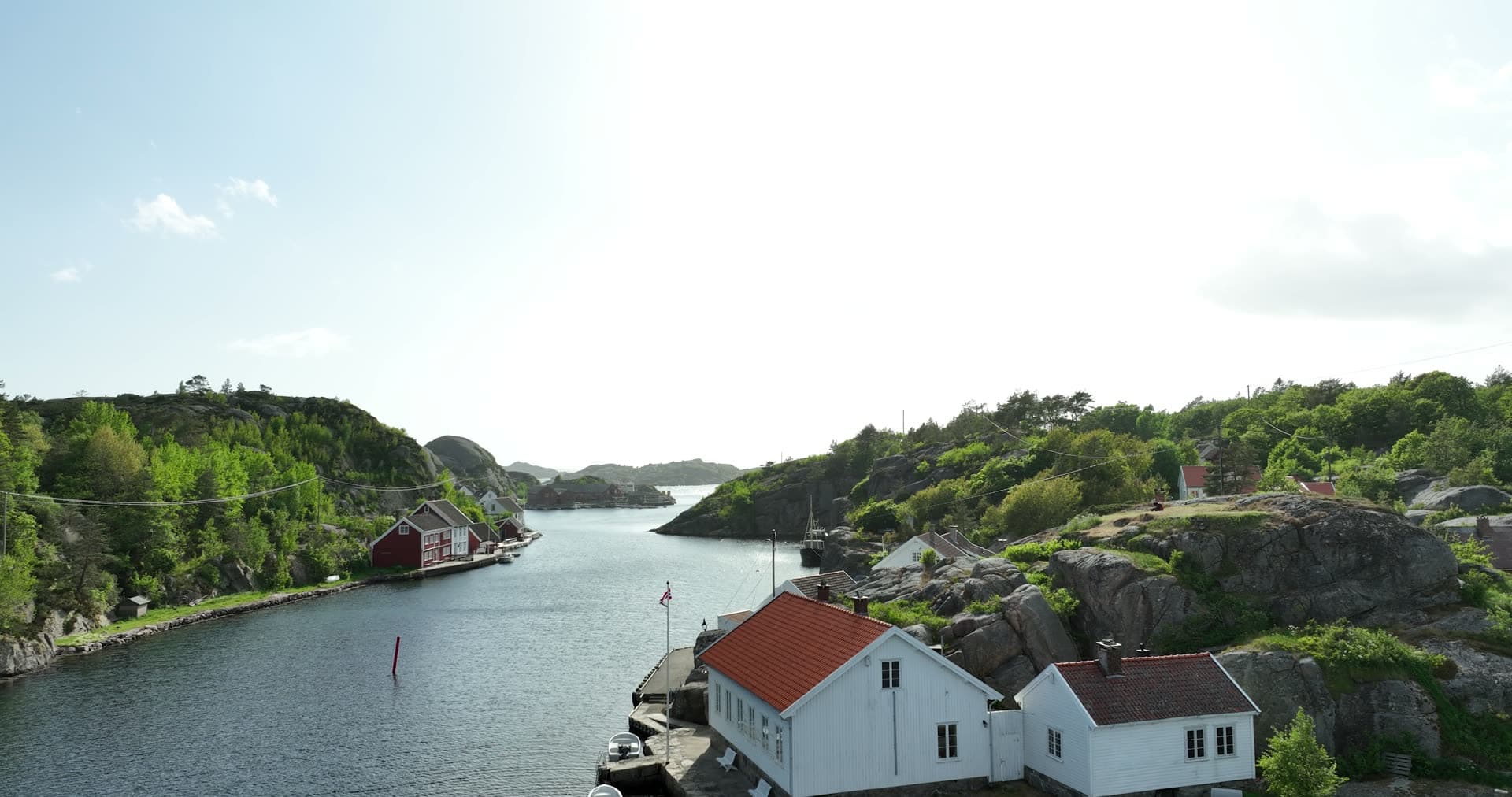 White houses along narrow granite passage, Ny-Hellesund, Norway