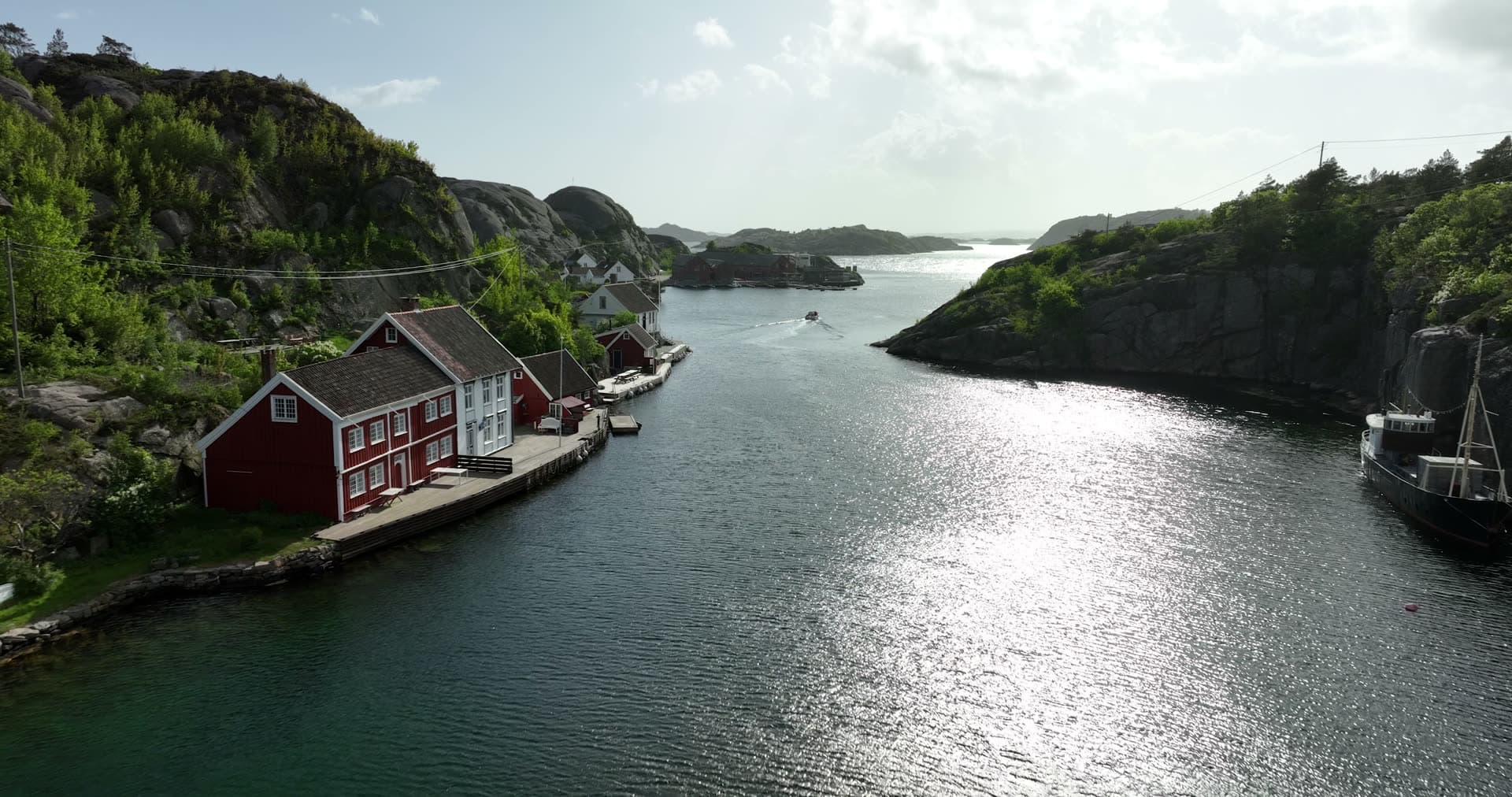 Sheltered harbor nestled between steep forested cliffs, Ny-Hellesund, Norway