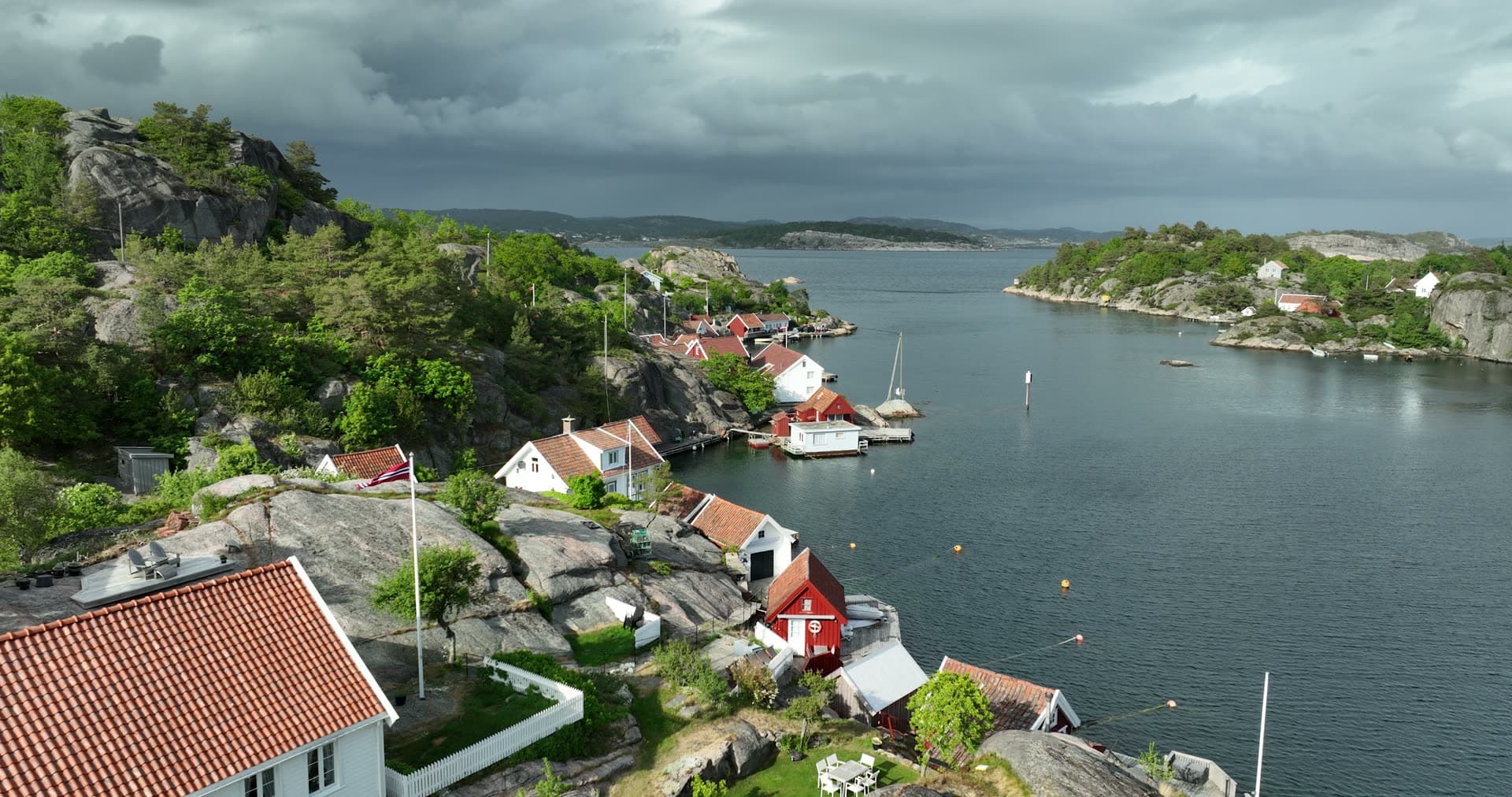 Dramatic storm clouds above sheltered harbor, Ny-Hellesund, Norway