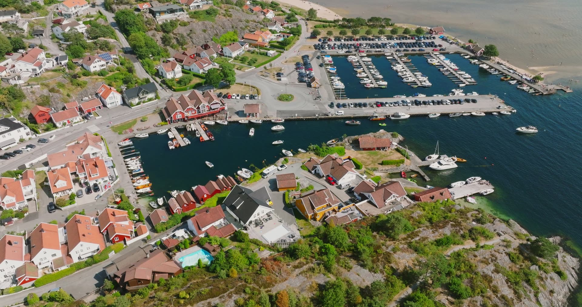 Large marina basin with orderly moored sailboats, Høllen, Norway