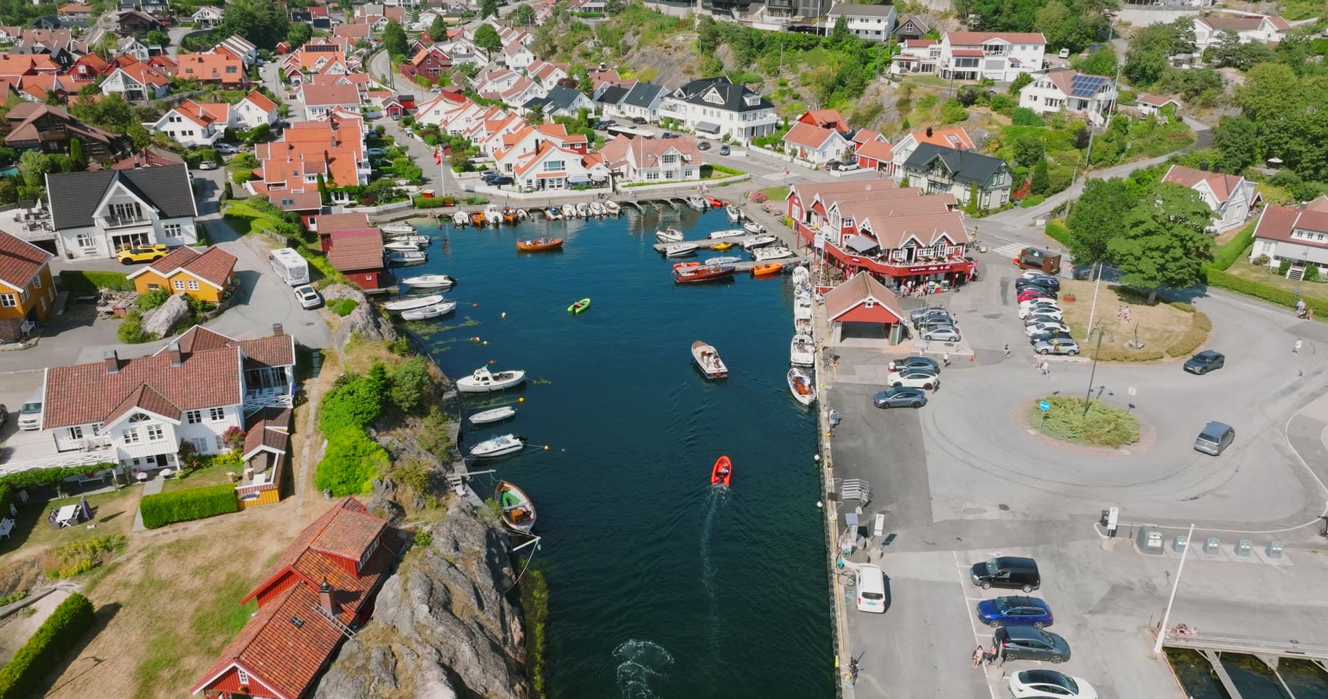 Narrow harbor basin with moored recreational and fishing boats, Høllen, Norway