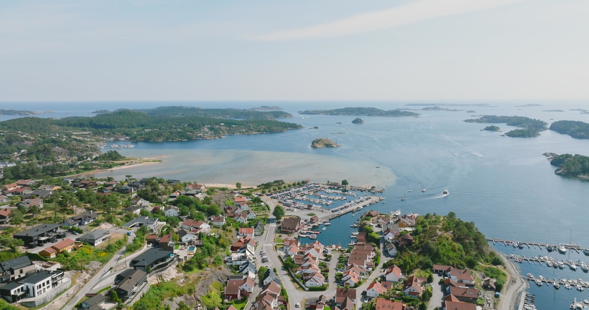 Crowded marina basin and residential hillside sprawl, Høllen, Norway