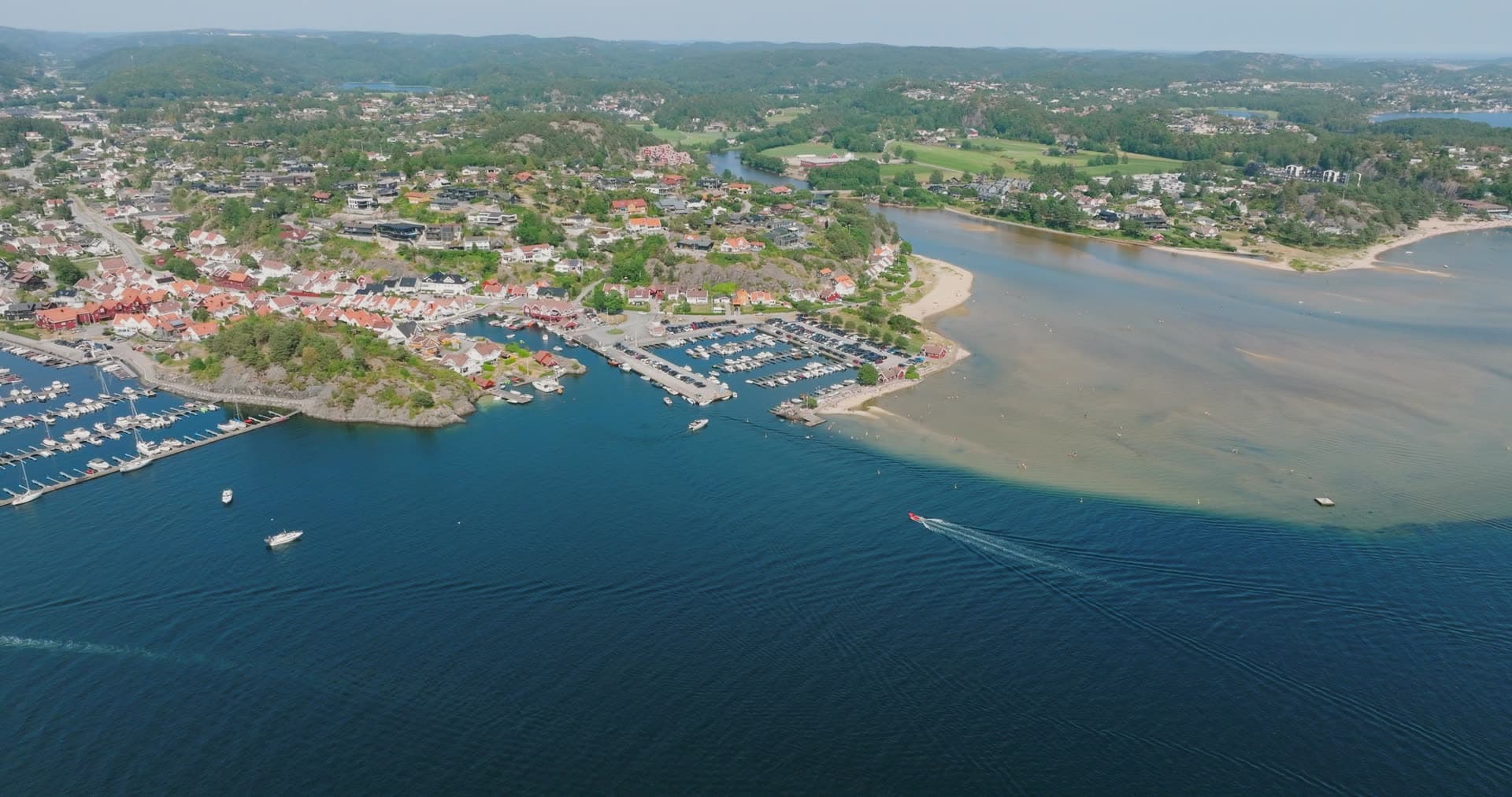 River mouth meeting sea at coastal marina, Høllen, Norway
