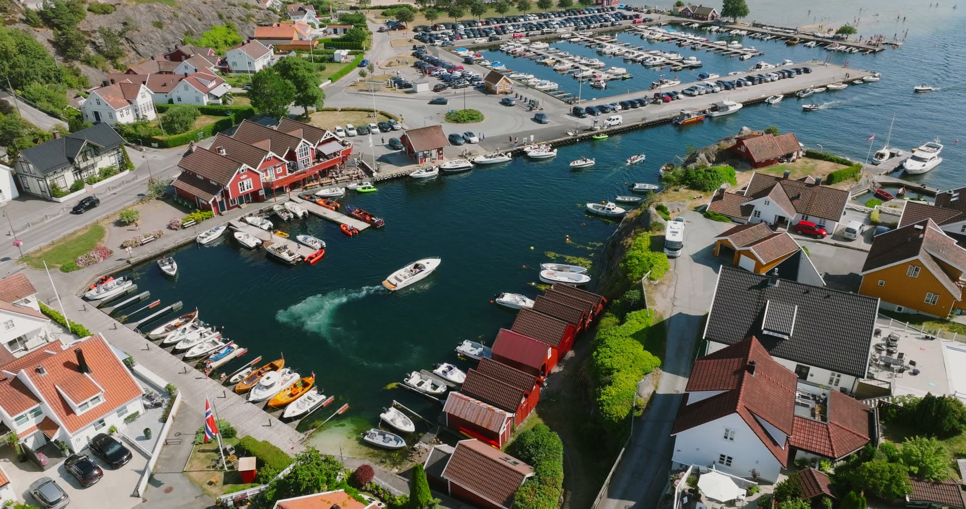 Moored fishing fleet and parking lot marina, Høllen, Norway