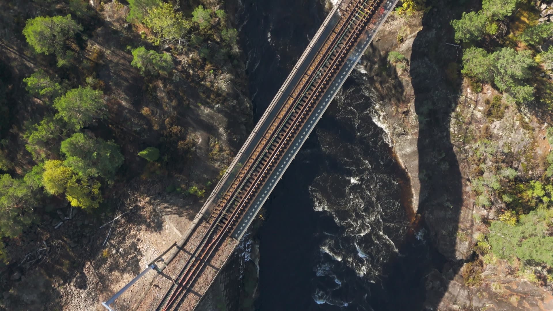Dual railway tracks spanning rocky gorge, Herefoss, Norway
