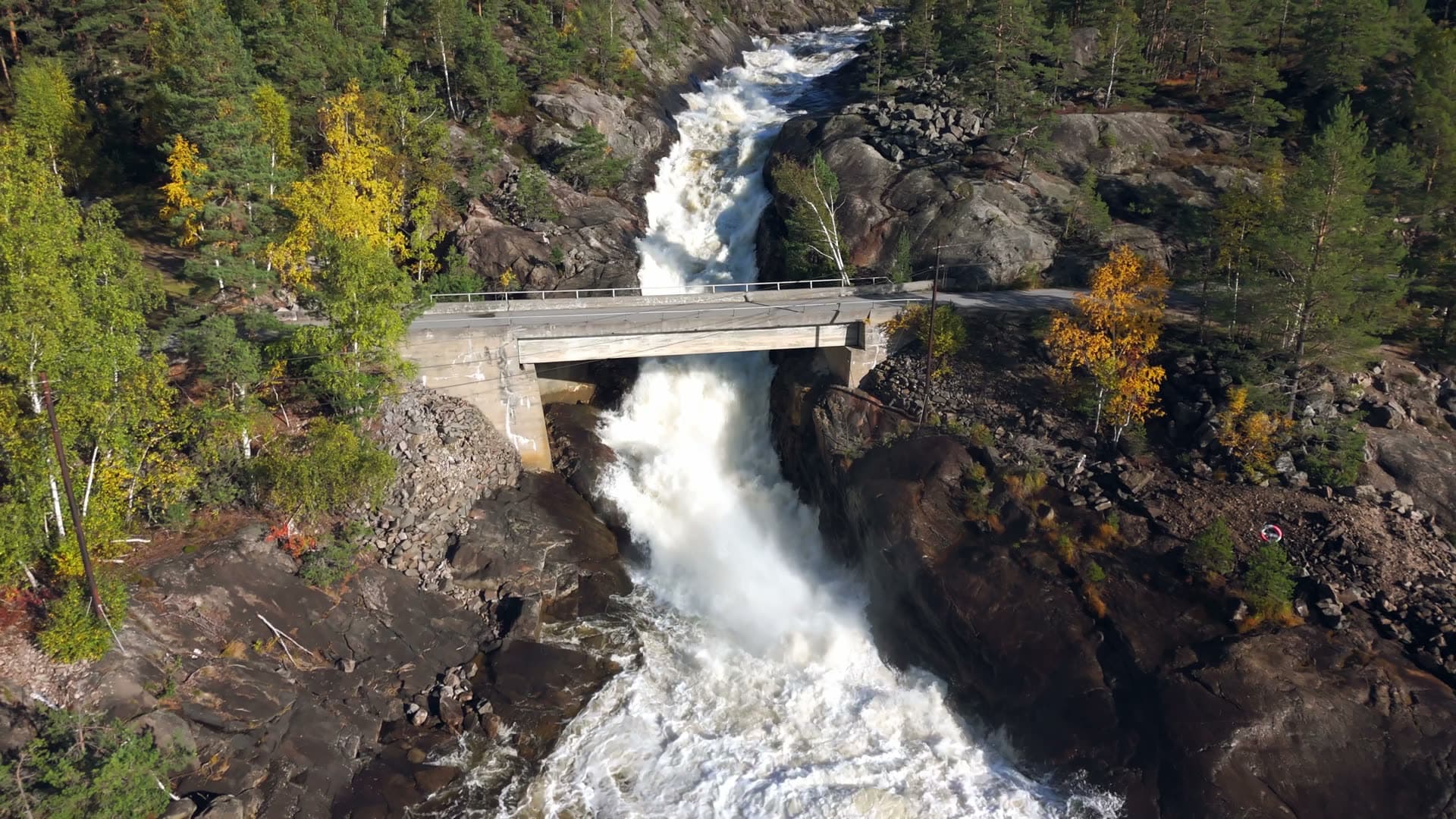 Concrete bridge spanning turbulent waterfall, Herefoss, Norway