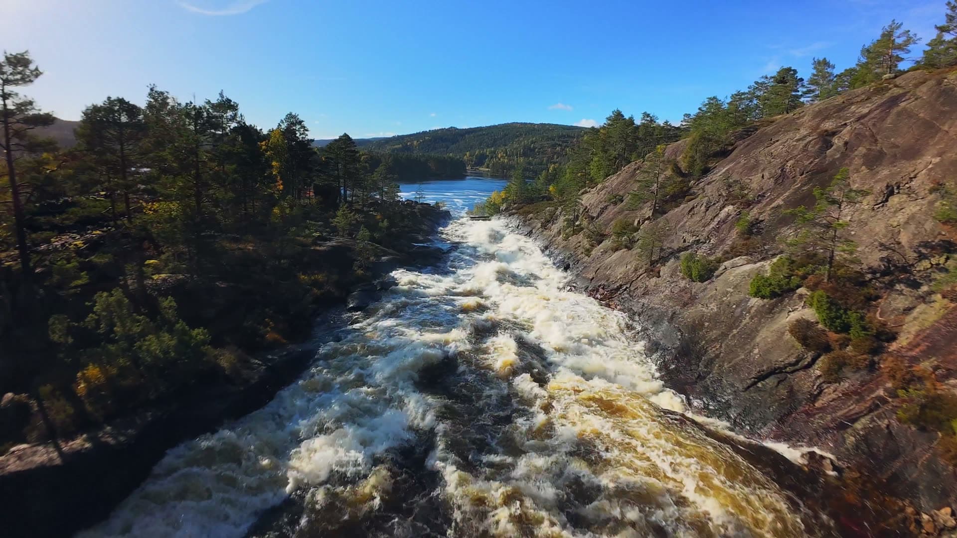 Powerful rapids descending toward calm lake, Herefoss, Norway