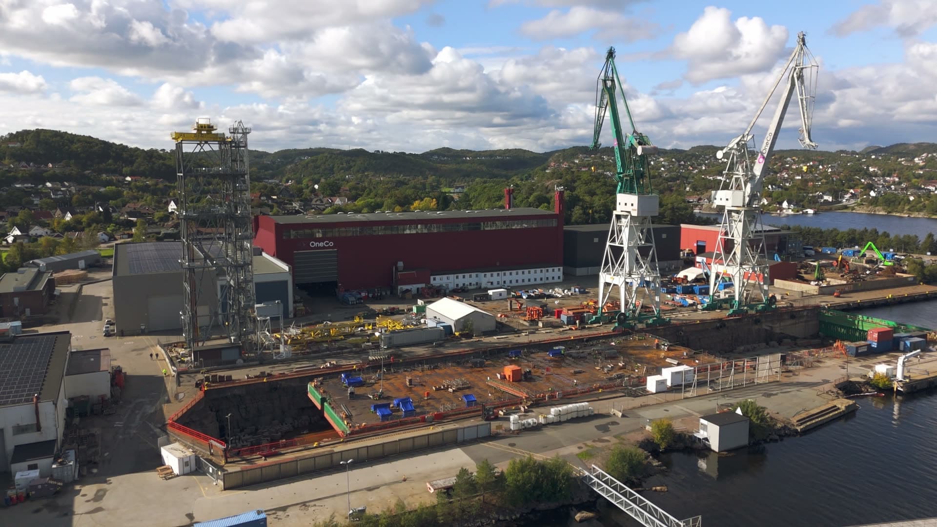 Active shipyard with dual cargo cranes and vessels, Kristiansand, Norway