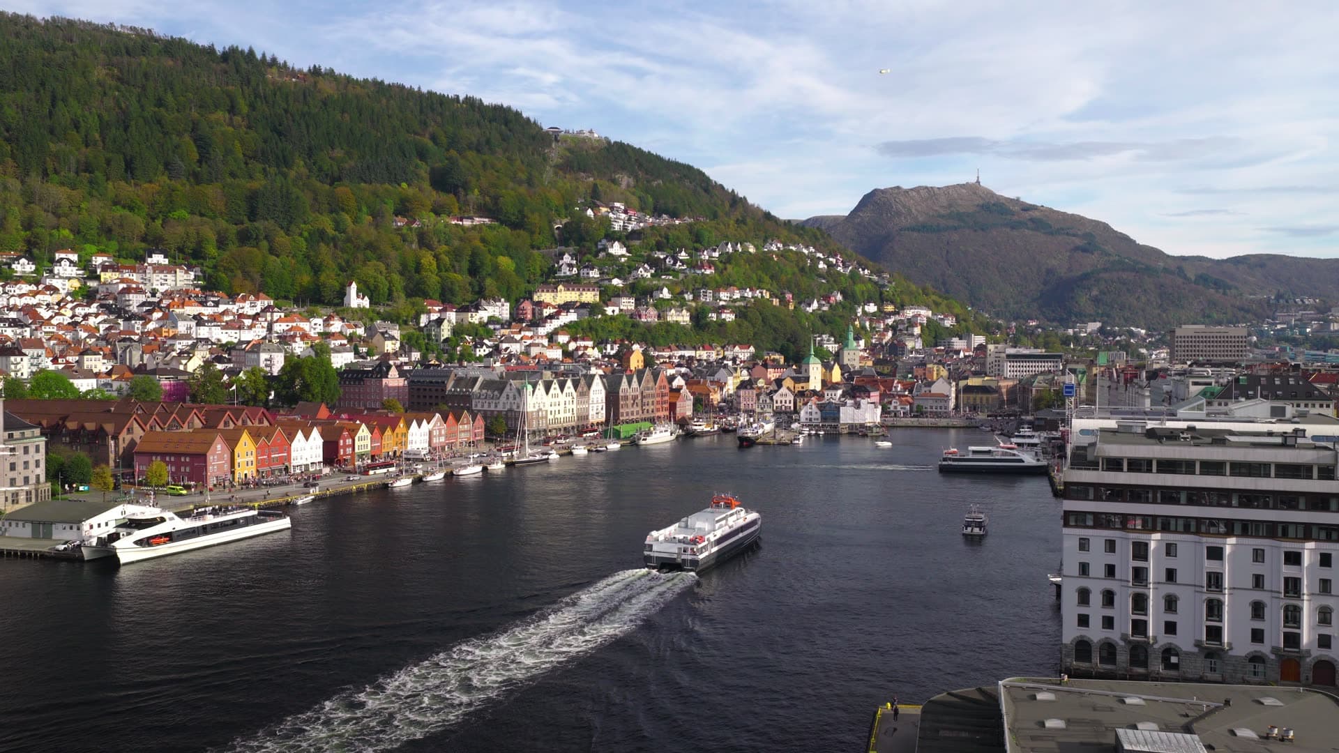 Passenger ferry crossing crowded harbor waters, Bryggen, Bergen, Norway