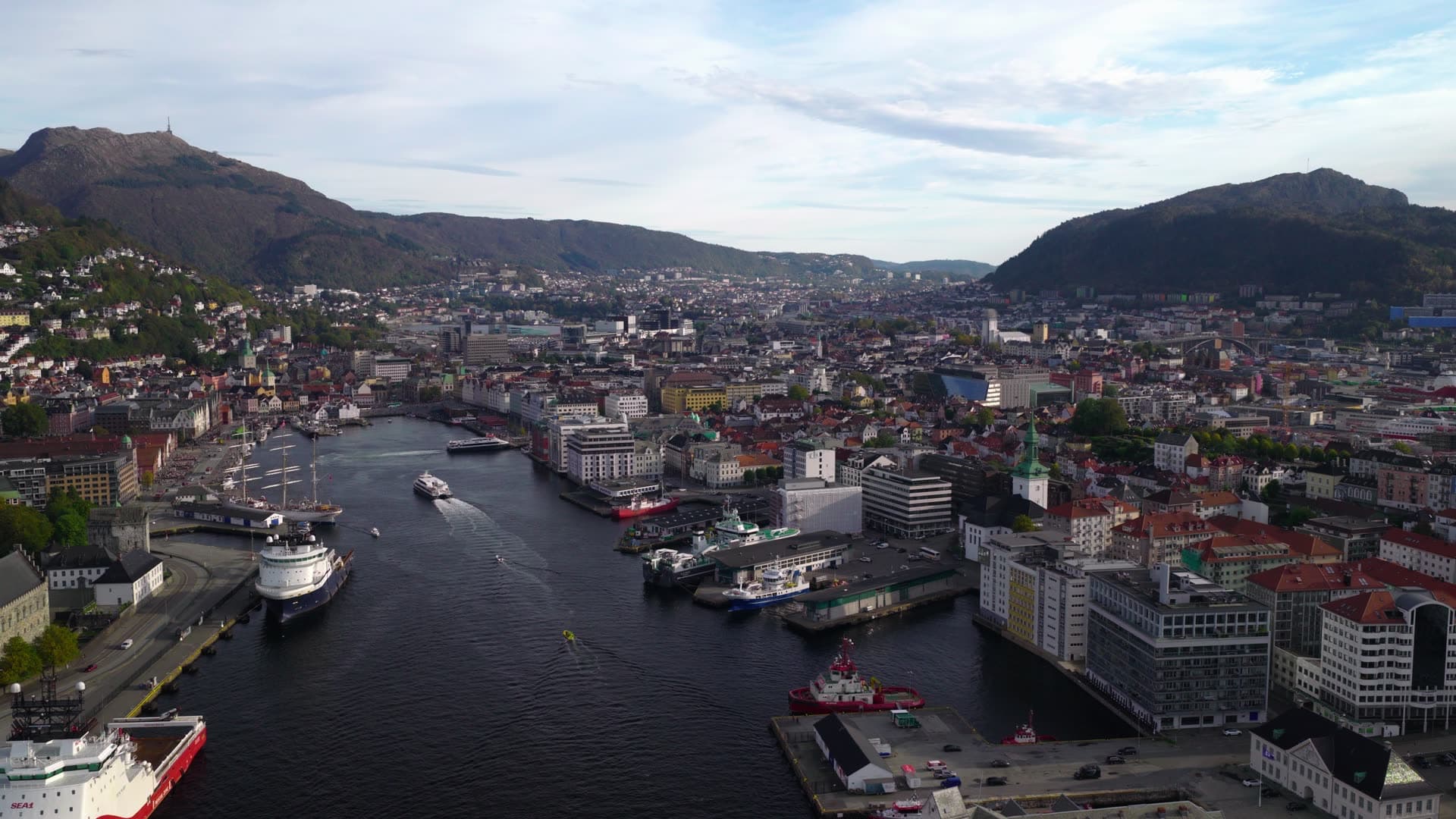 Multiple cargo ships in industrial harbor basin, Bryggen, Bergen, Norway