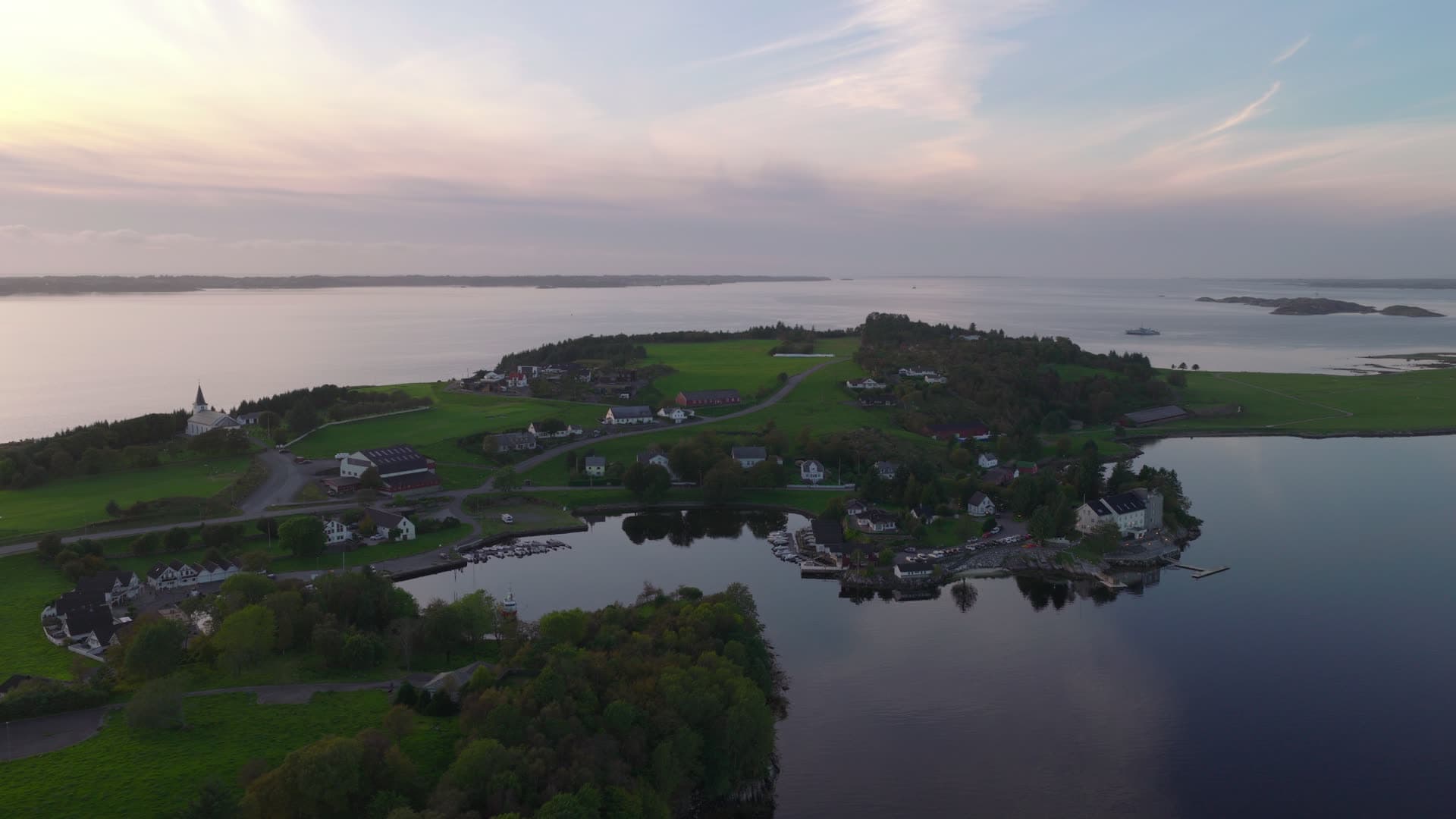 Island village with church and waterfront, Herdla