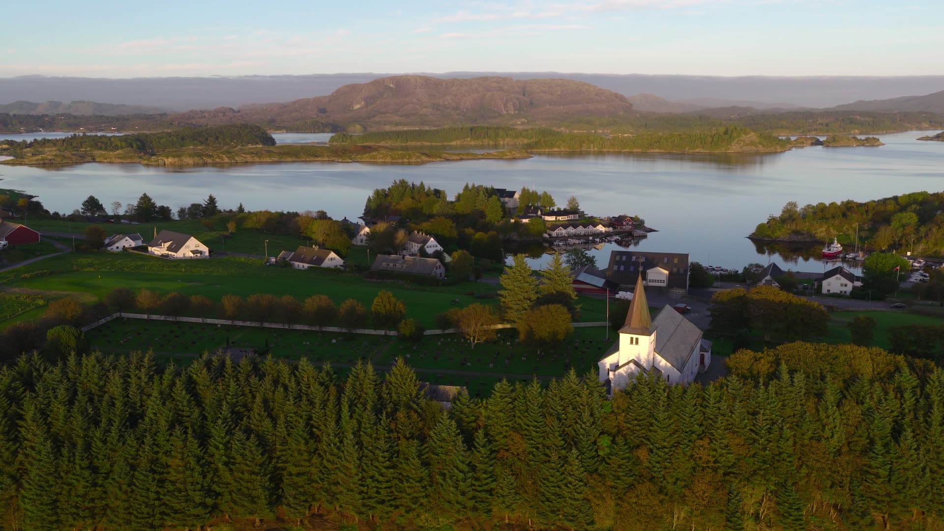 White church overlooking fjord village, Herdla