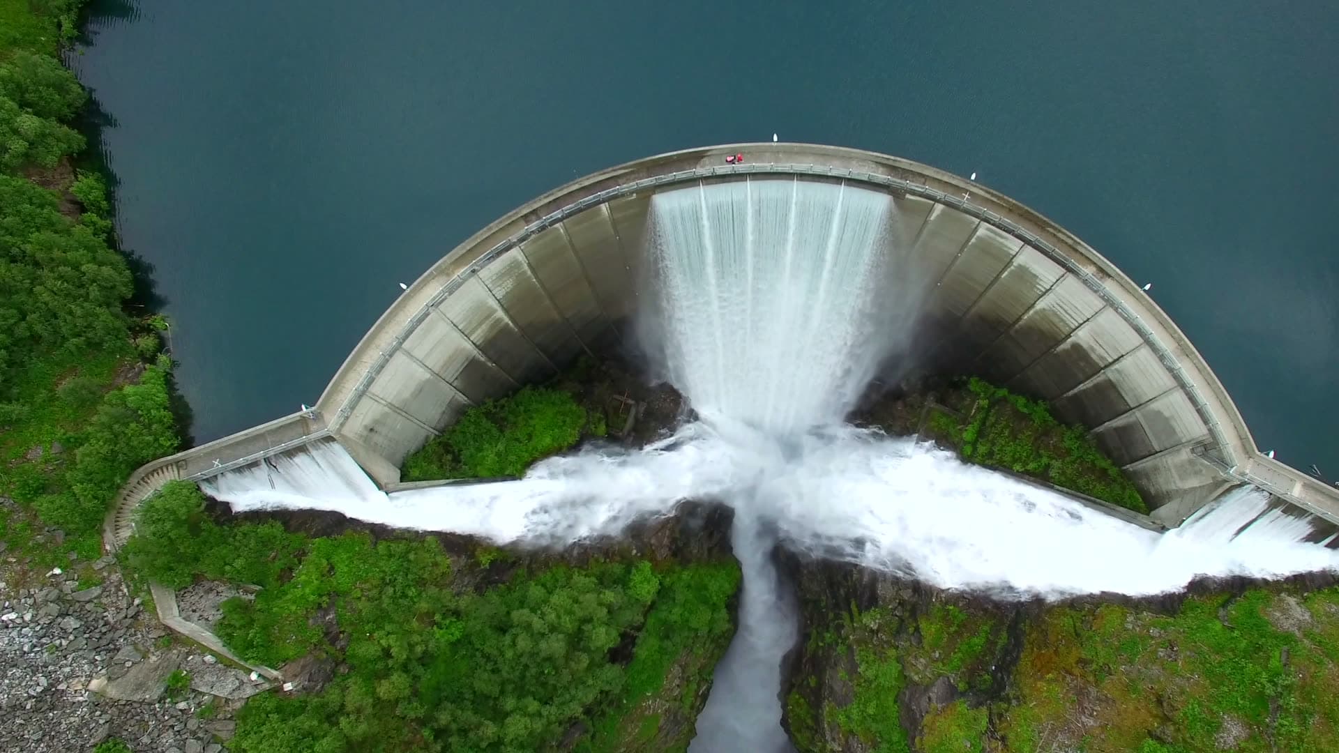 Wide frontal aerial view of overflowing Zakariasdammen in Tafjord