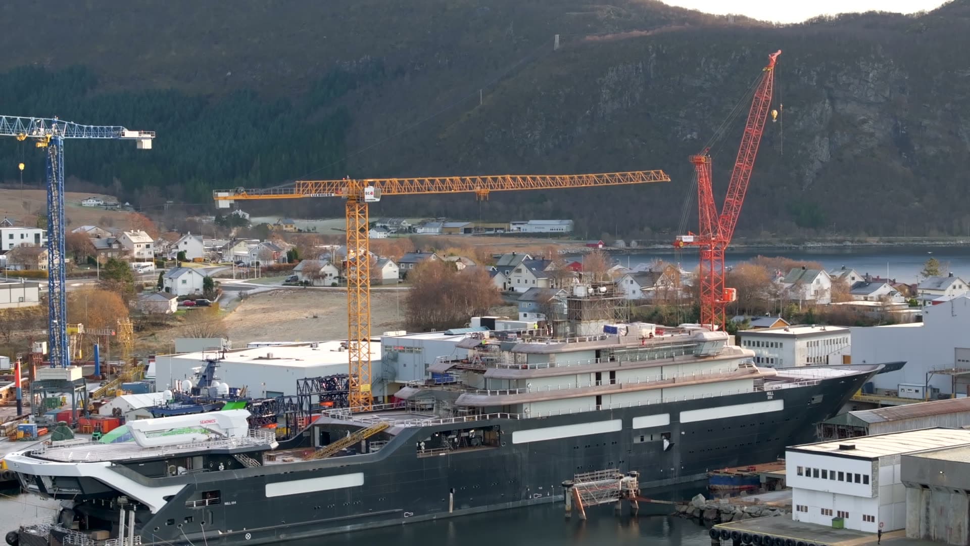 Angled aerial view of REV Ocean and shipyard cranes in Søvik