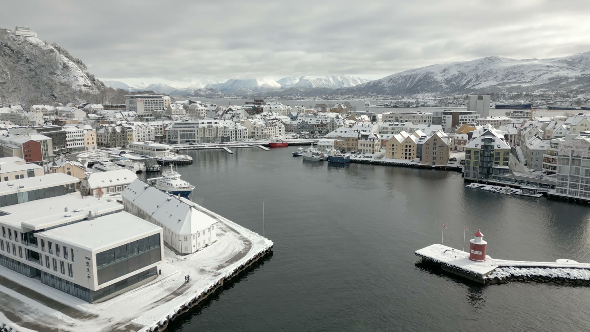 Snow covered waterfront and harbour entrance in Ålesund