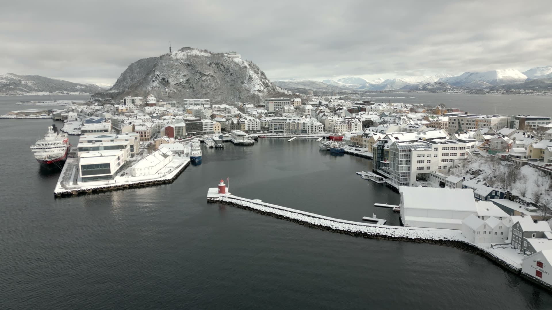 Retreating winter aerial view of Ålesund harbour and breakwaters