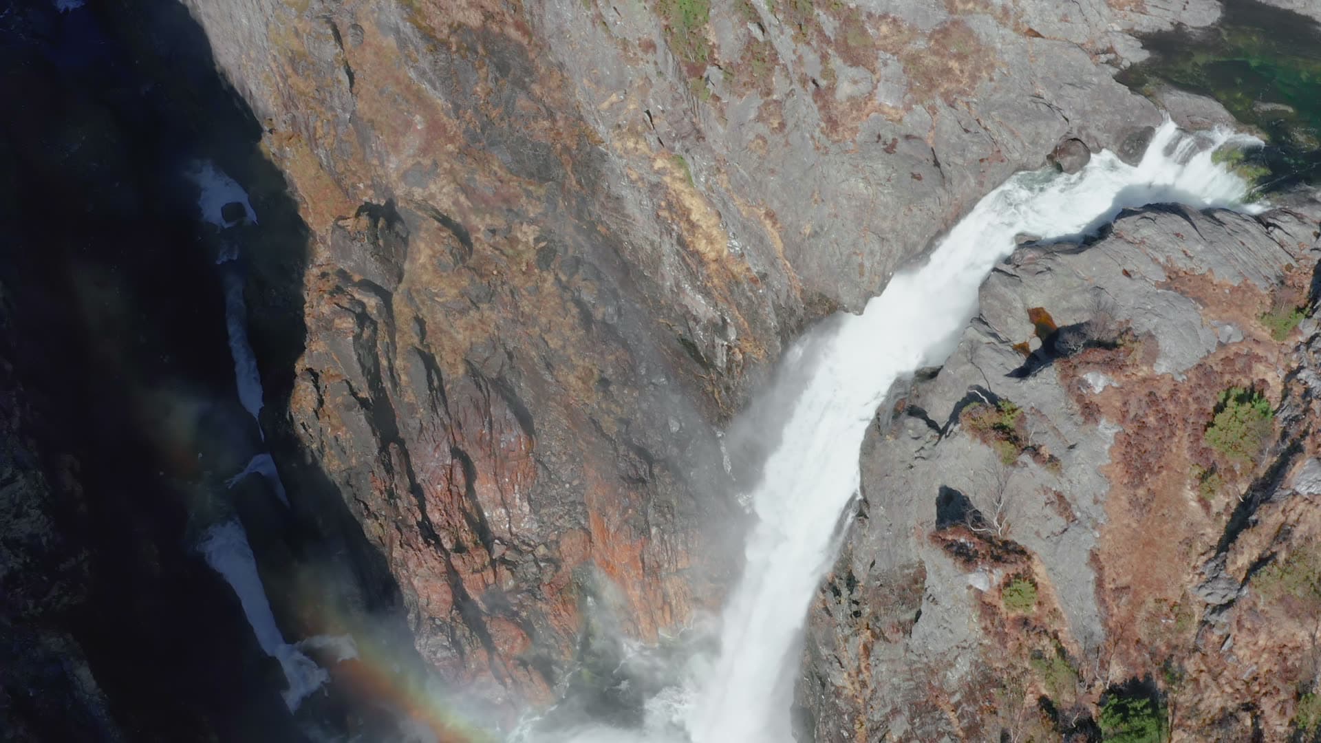 Waterfall flowing through deep canyon, Månafossen