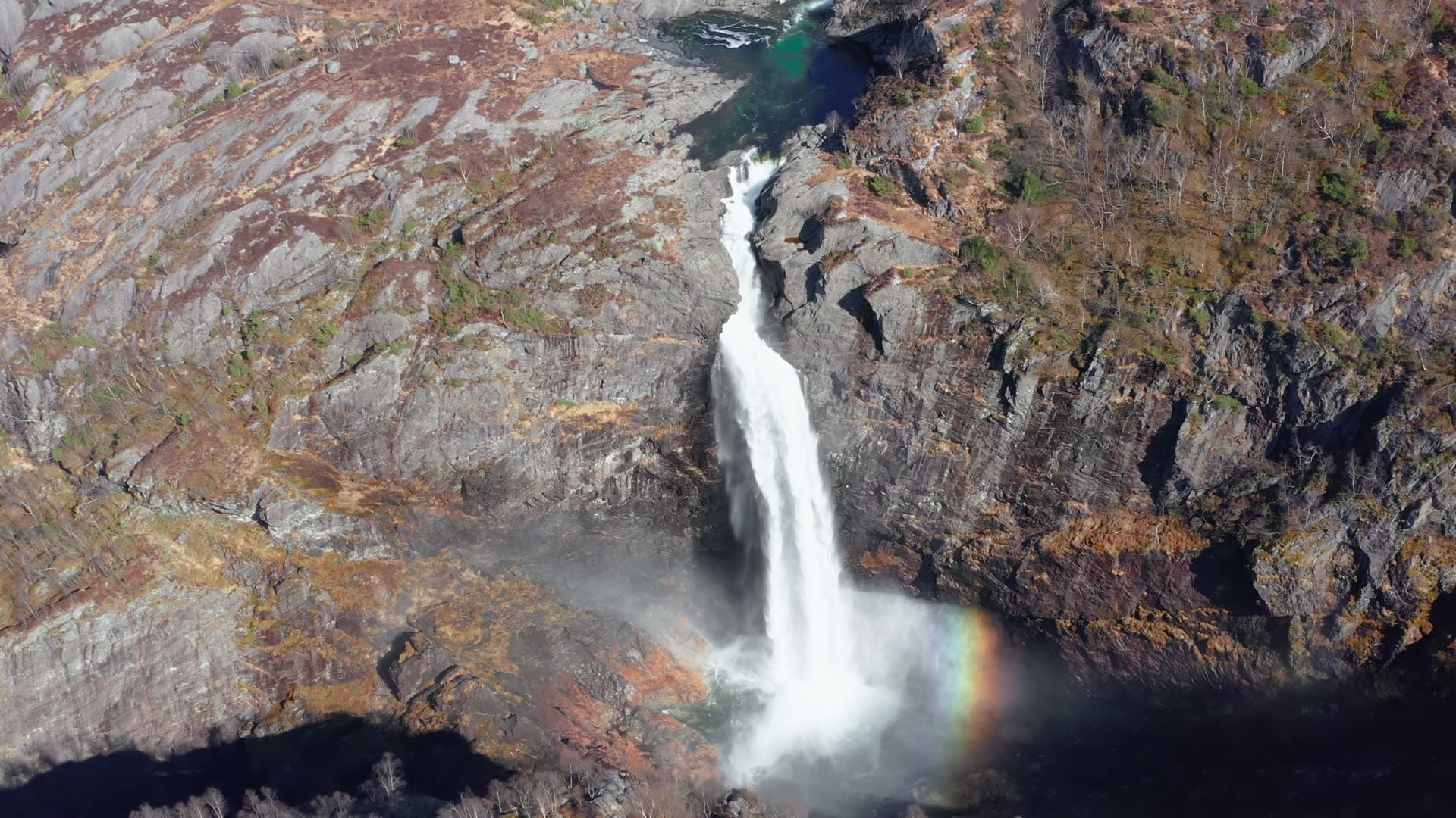 Waterfall flowing through rocky gorge, Månafossen