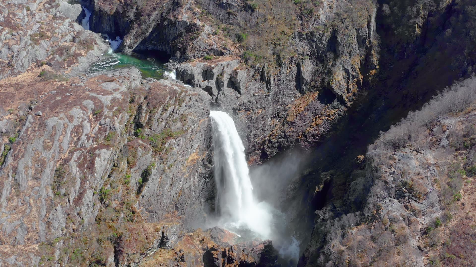 Waterfall cascading into rocky canyon, Månafossen