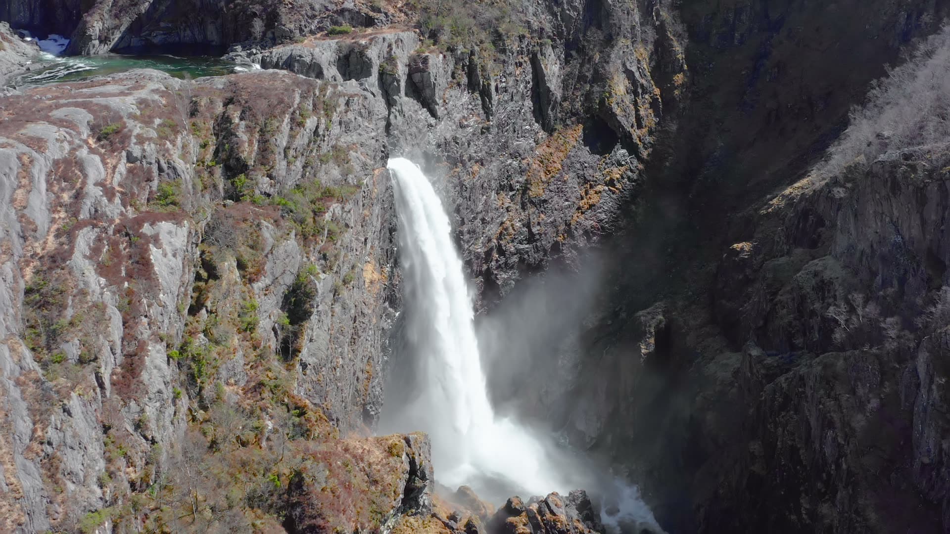 Waterfall cascading through deep rocky canyon, Månafossen