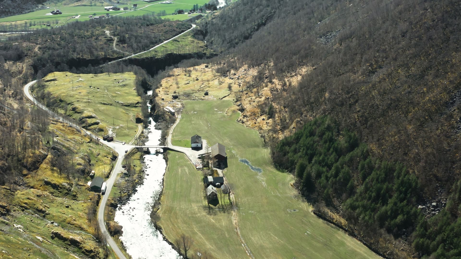 Alpine valley with winding river and scattered farms, Månafossen