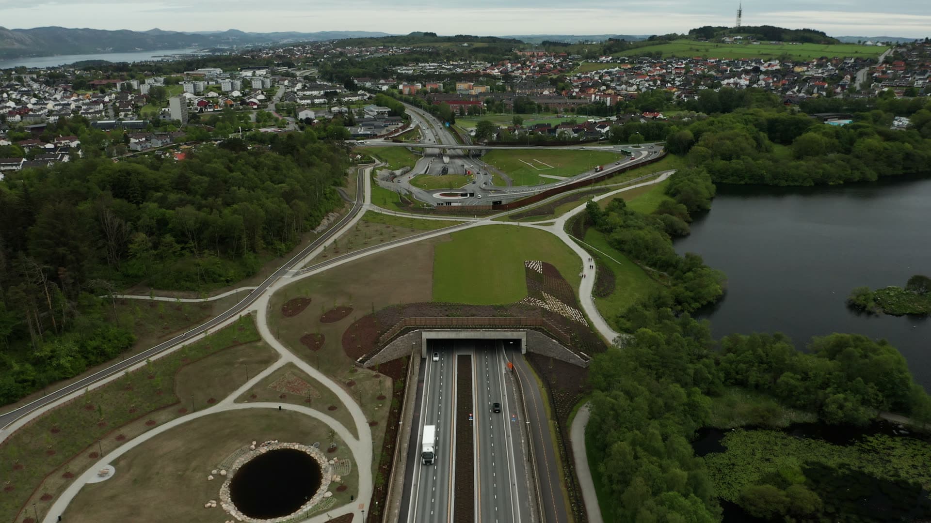 Highway tunnel through forest and lake, Stavanger