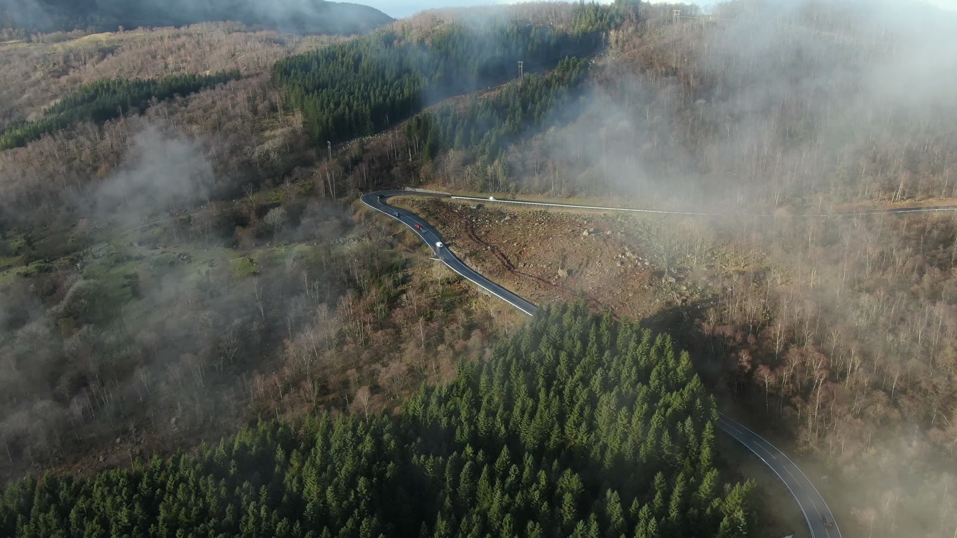Winding mountain road through misty valleys, Ingvaldstad