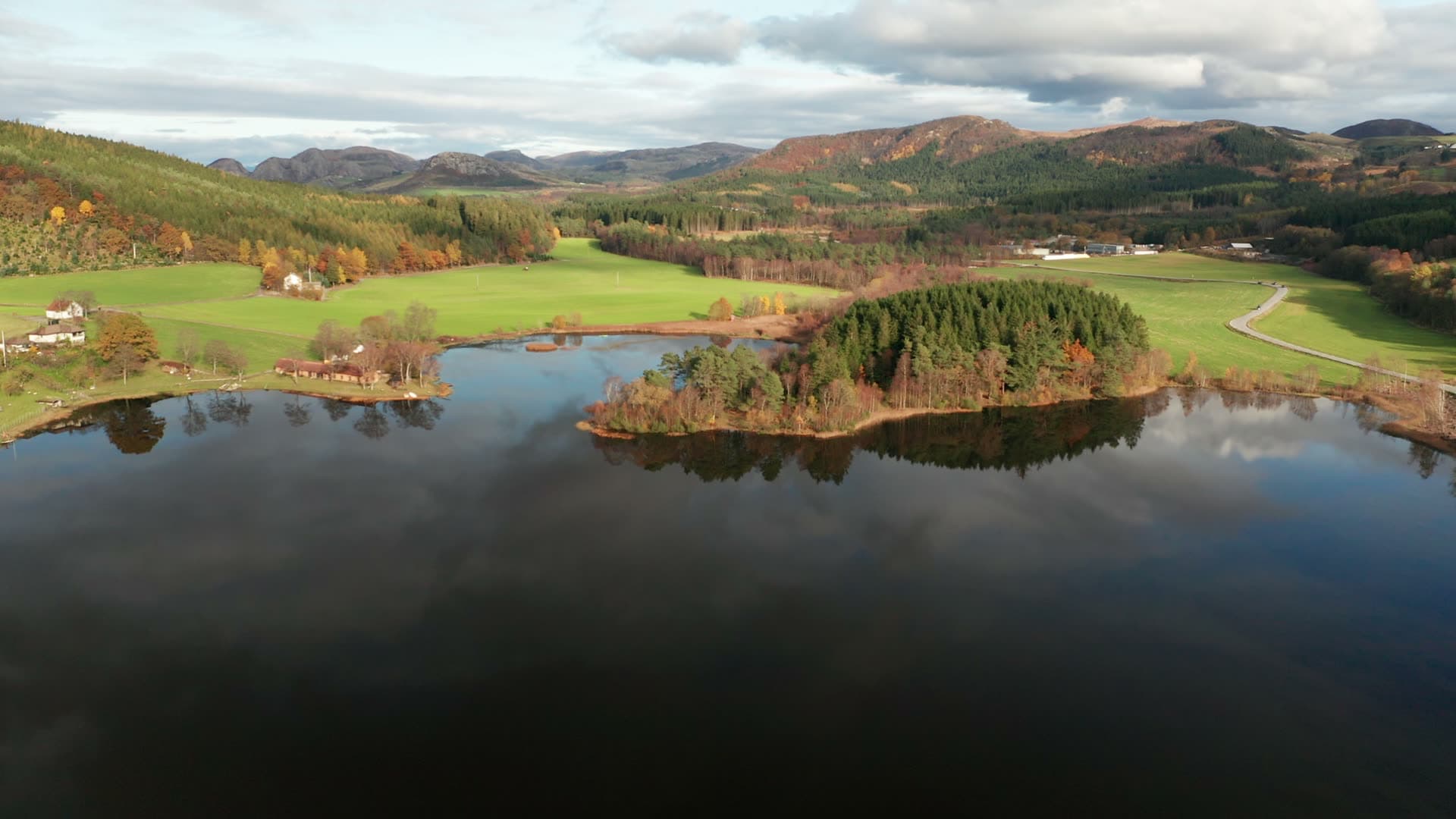 Lake with forested island and countryside, Bråsteinvatnet