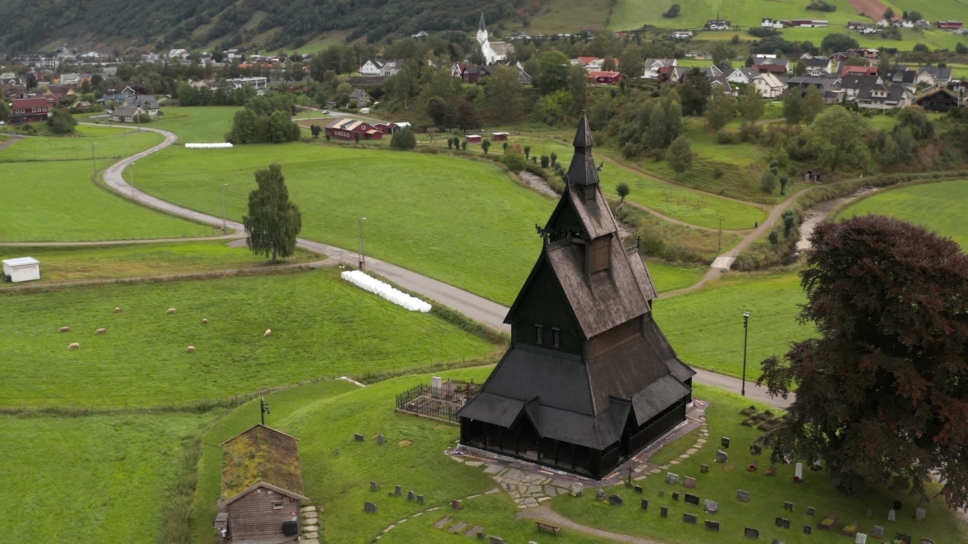 Black wooden stave church in valley, Hopperstad stavkirke