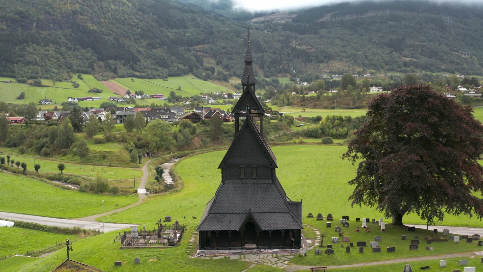Black wooden stave church in mountain valley, Hopperstad stavkirke