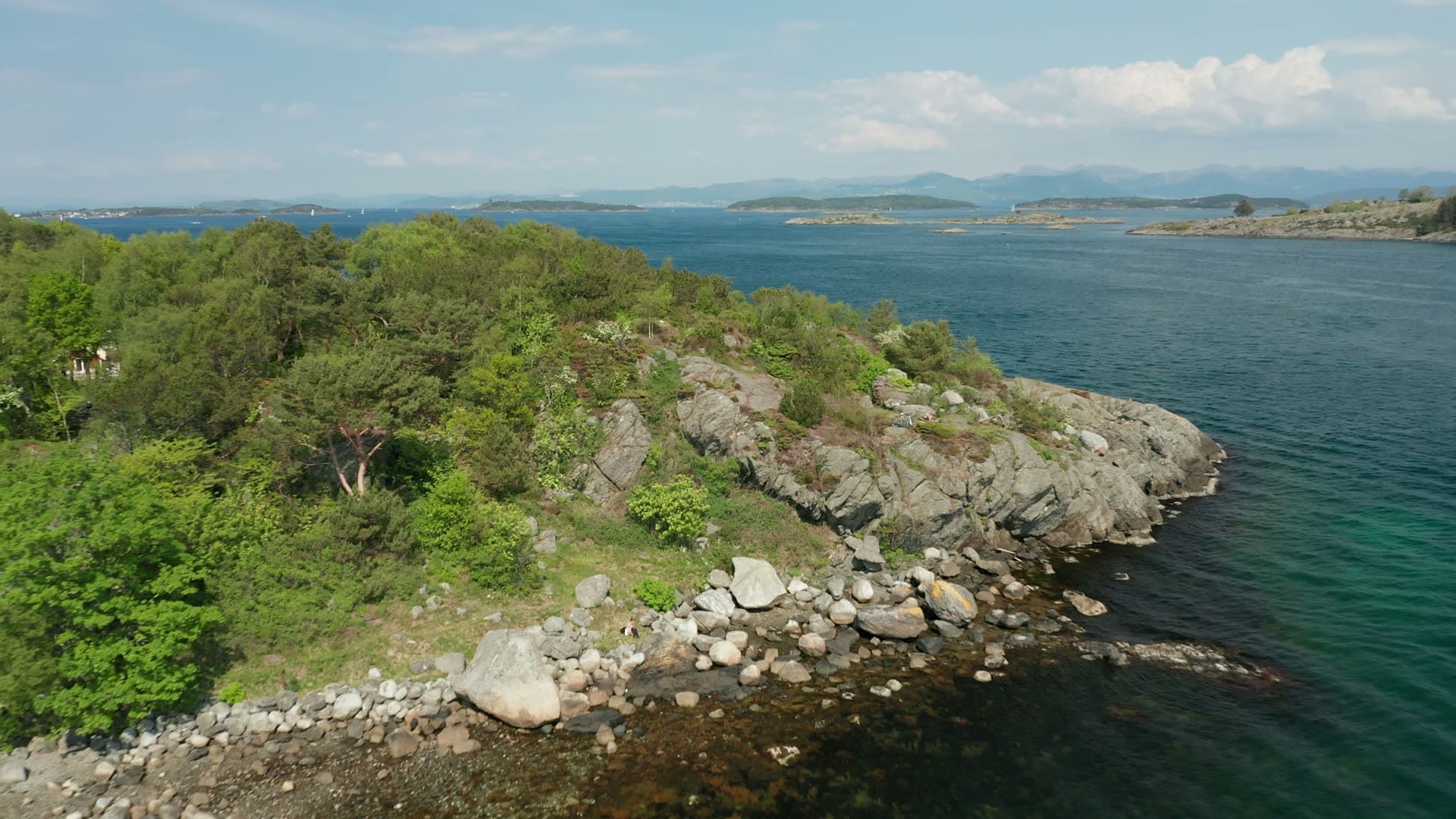 Rocky coastal headland with forest and cove, Stavanger
