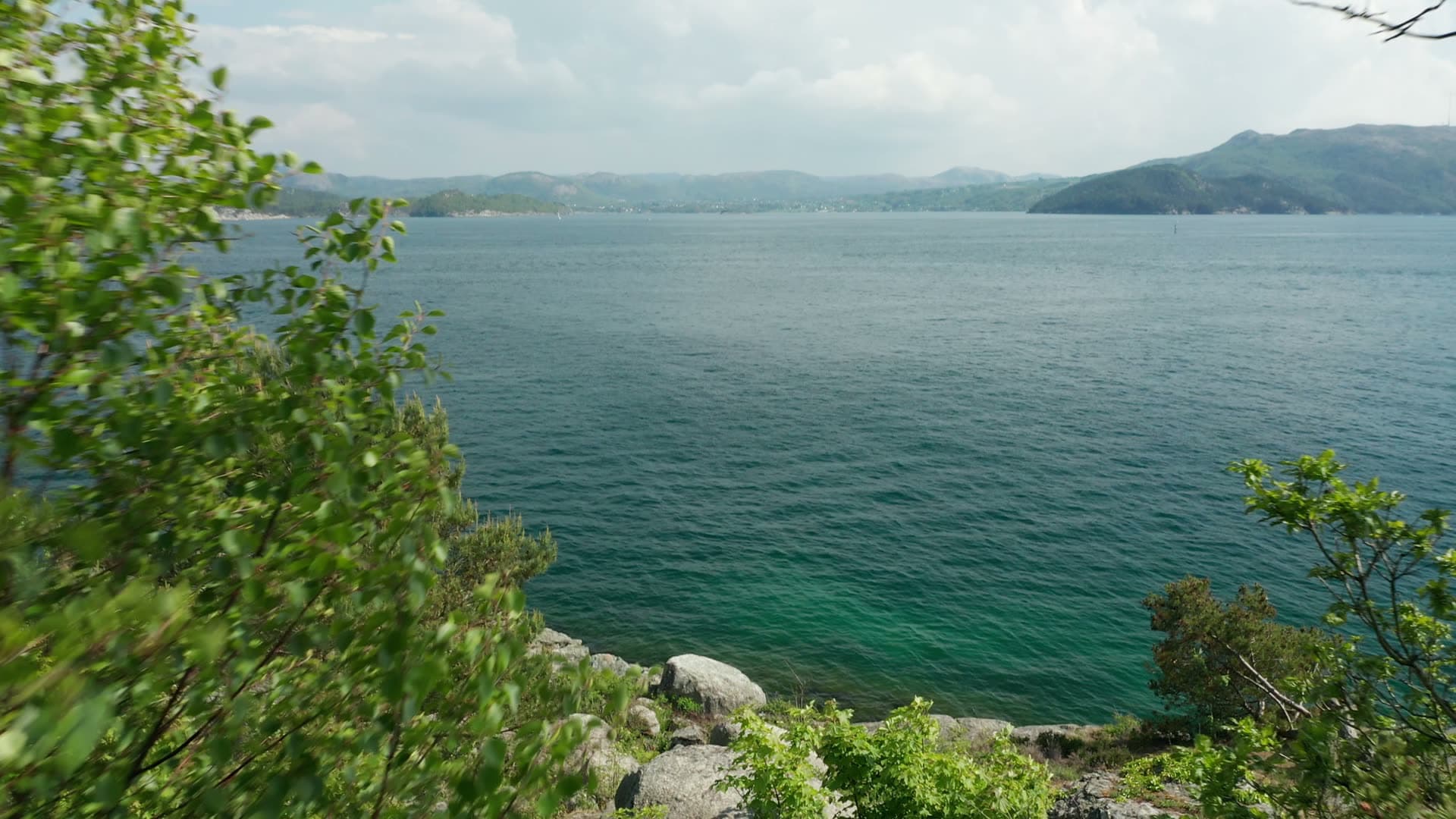 Rocky coastal landscape with distant mountains, Stavanger