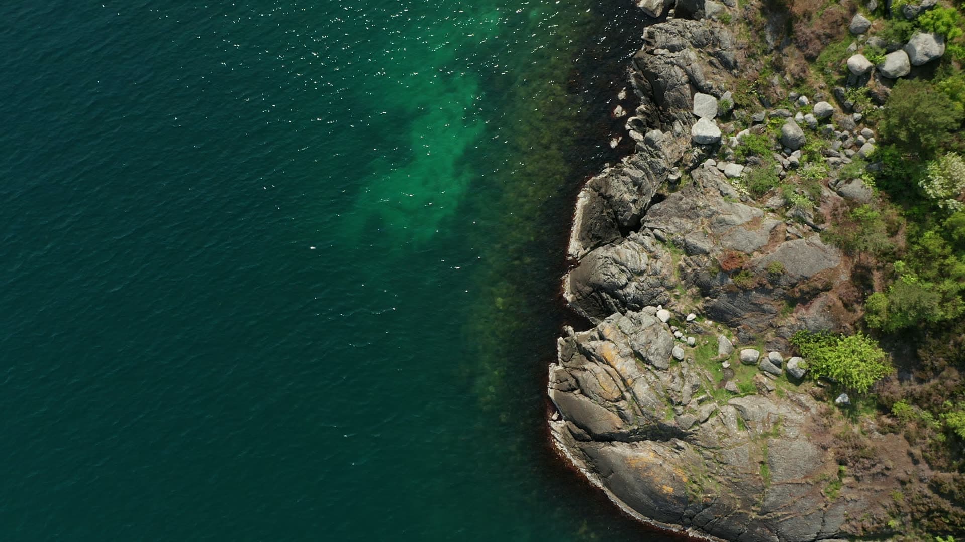 Rocky coastal cliff with turquoise water, Stavanger