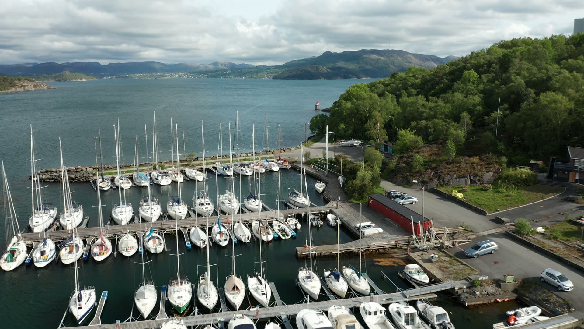 Sailboats moored in fjord harbor, Lervig