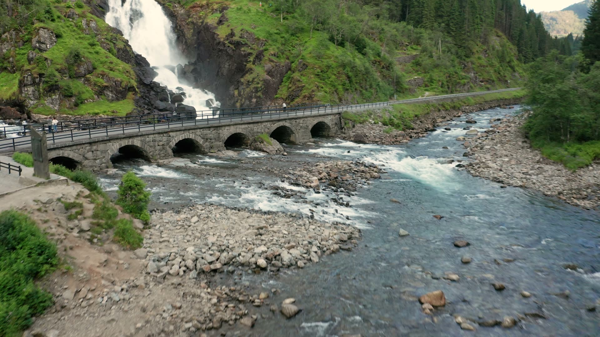 Alpine river with stone bridge and waterfalls, Låtefossen