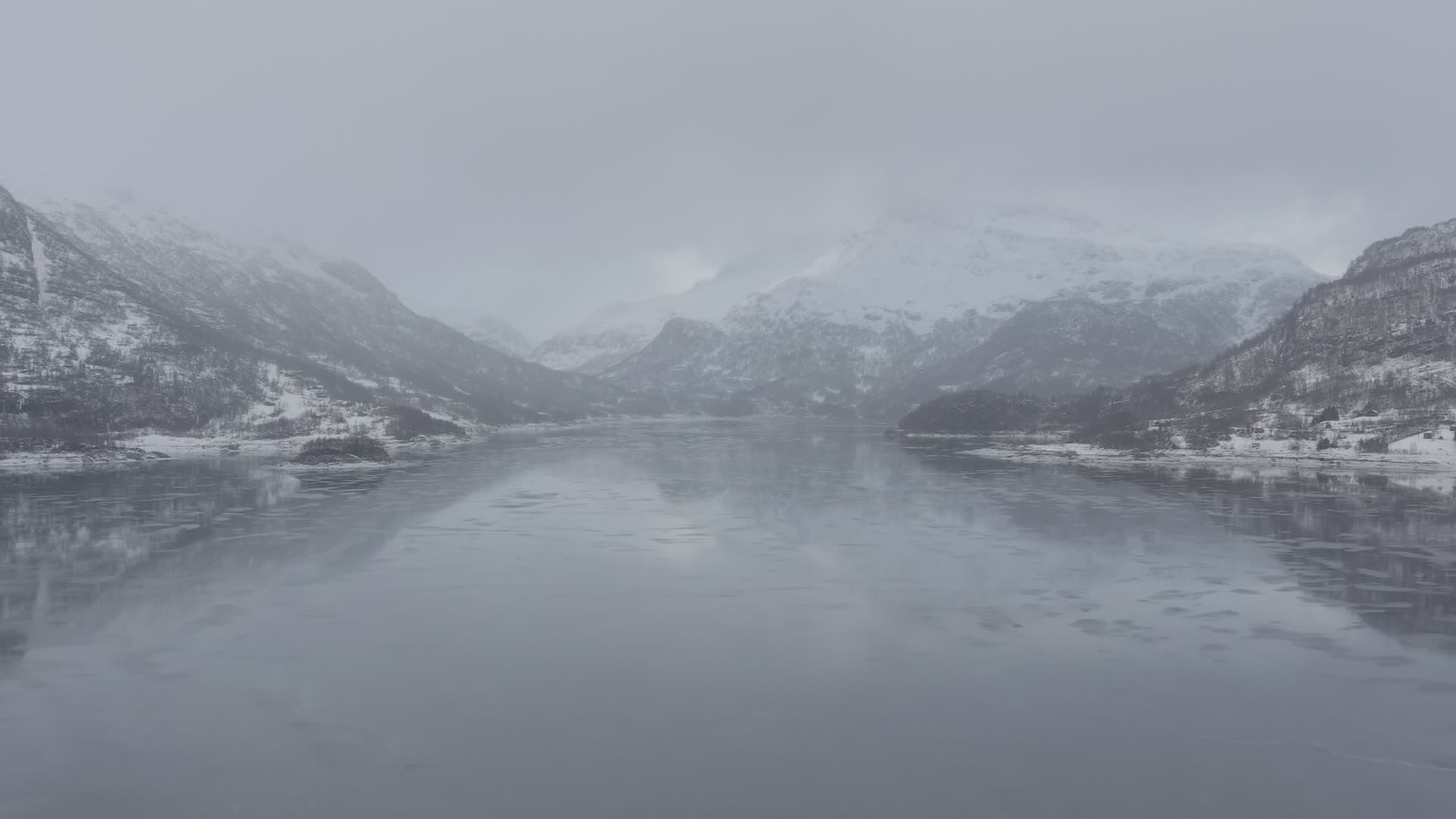 Frozen mountain lake in winter valley, Slettedalsvatnet