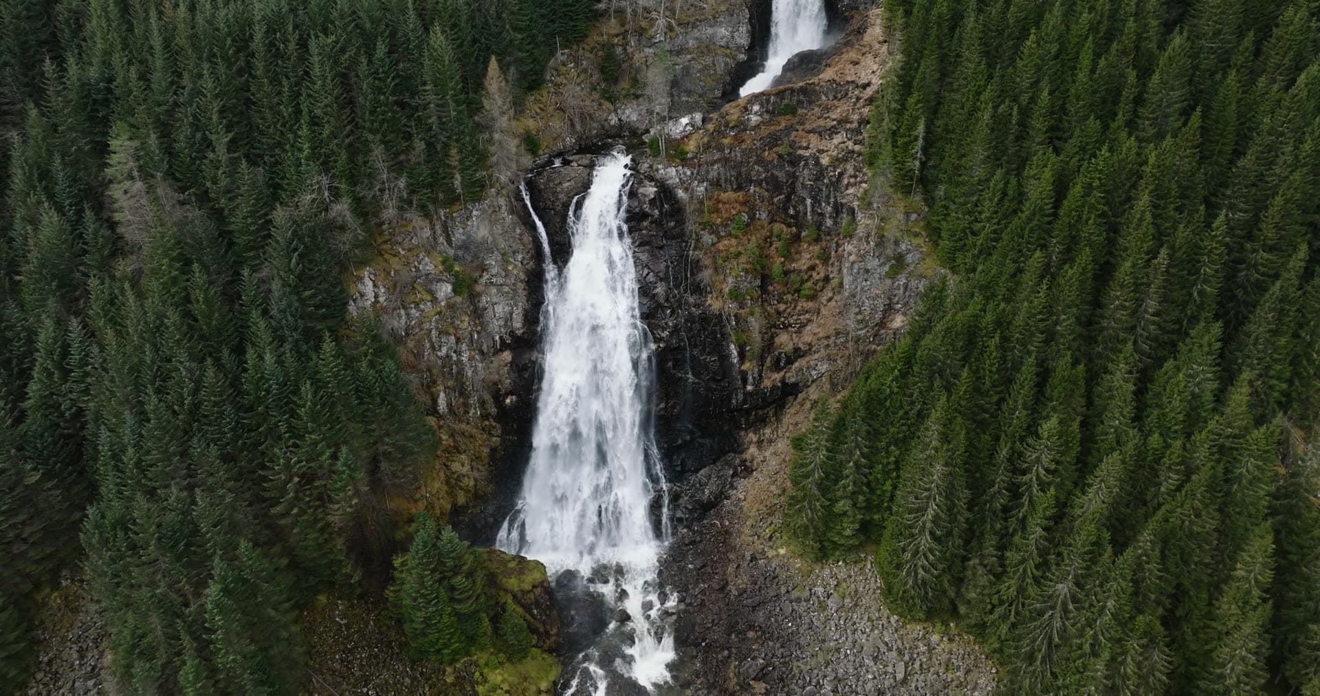 Waterfall in forested mountain valley, Låtefossen