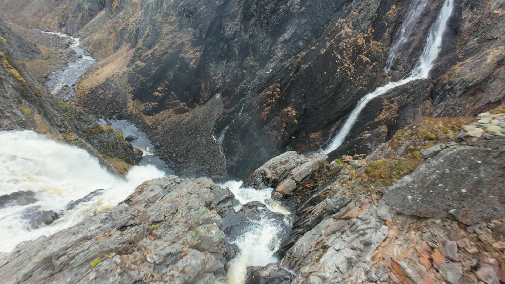 Waterfall and suspension bridge in mountain gorge, Vøringsfossen