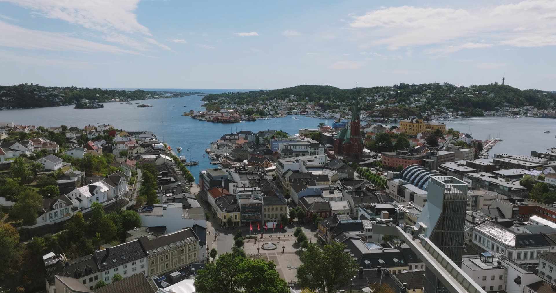 Curved modern building overlooking town square and waterfront, Arendal, Norway