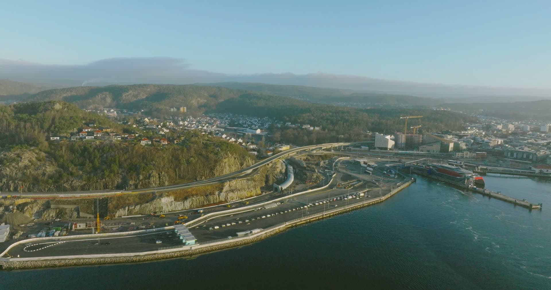 Highway interchange curving above forested promontory, Kristiansand, Norway