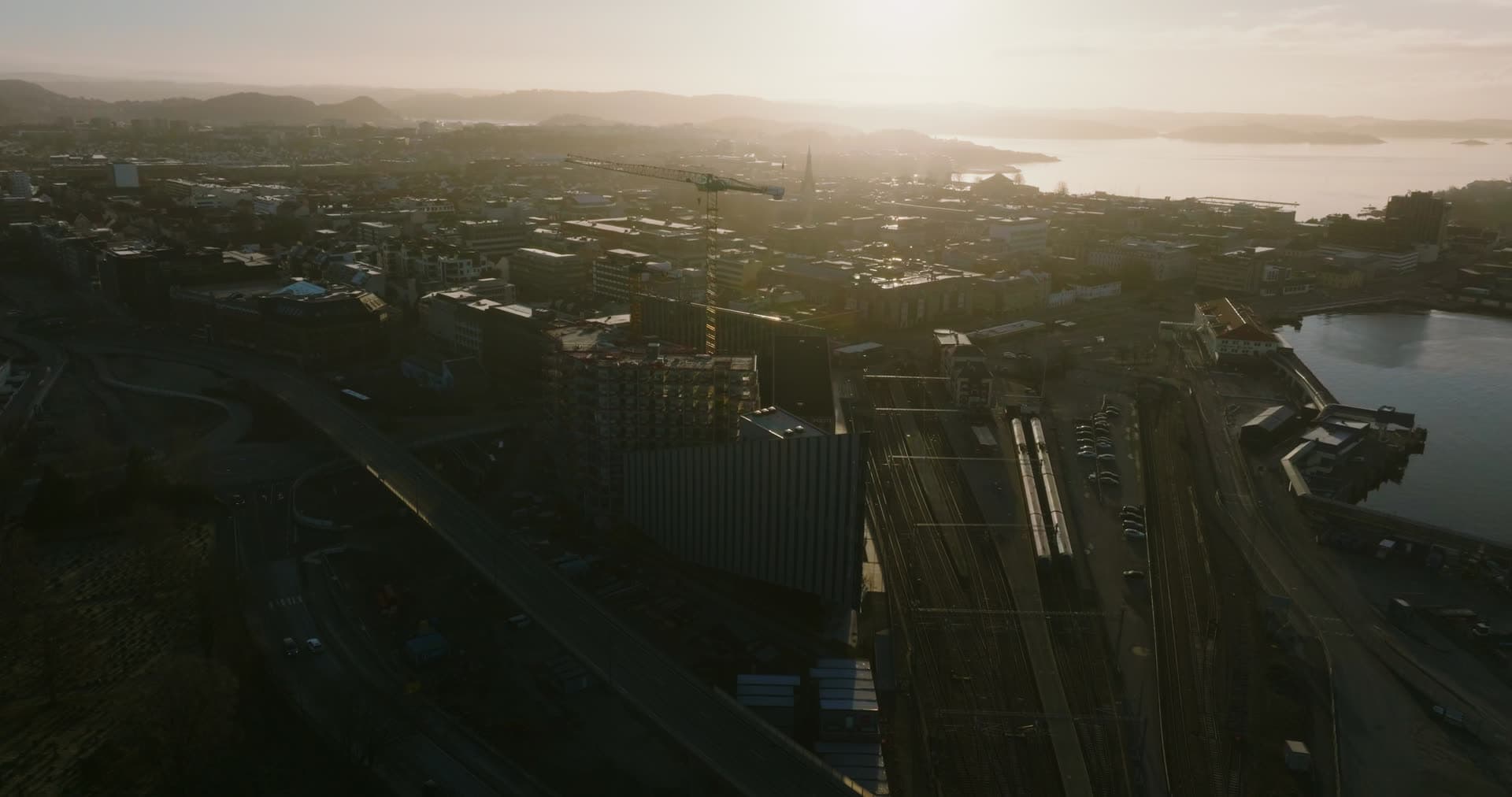 Rail tracks and industrial yard in golden haze, Kristiansand, Norway