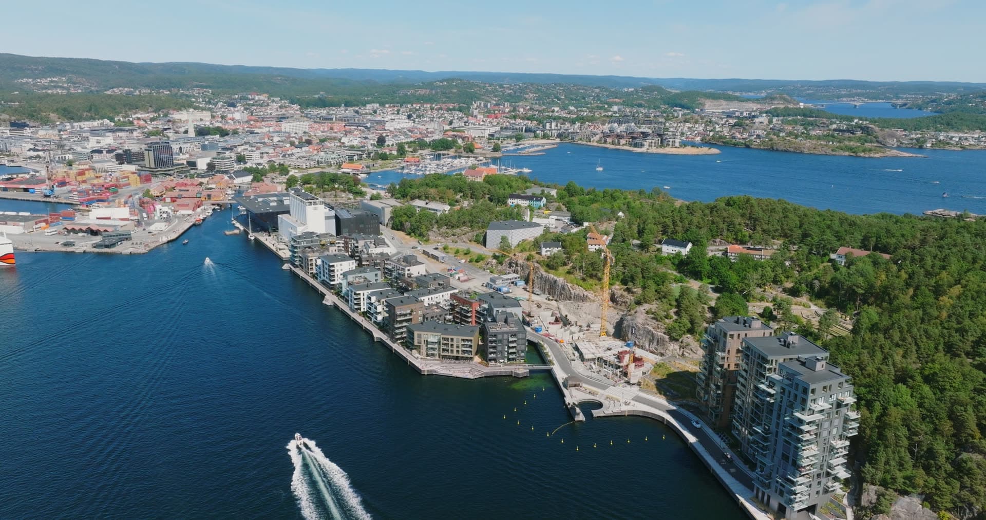 Speedboat wake crossing the inner harbor basin, Kristiansand, Norway