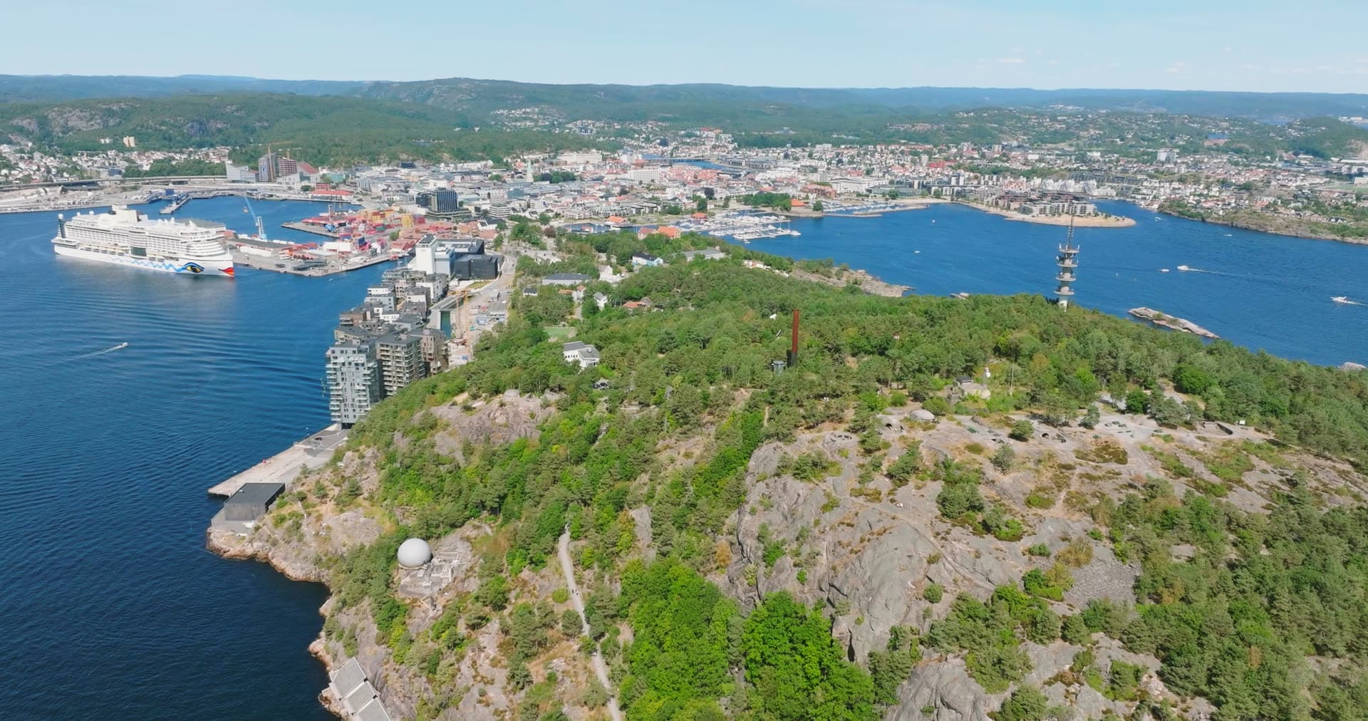 Rocky headland with dense forest and observation dome, Kristiansand, Norway