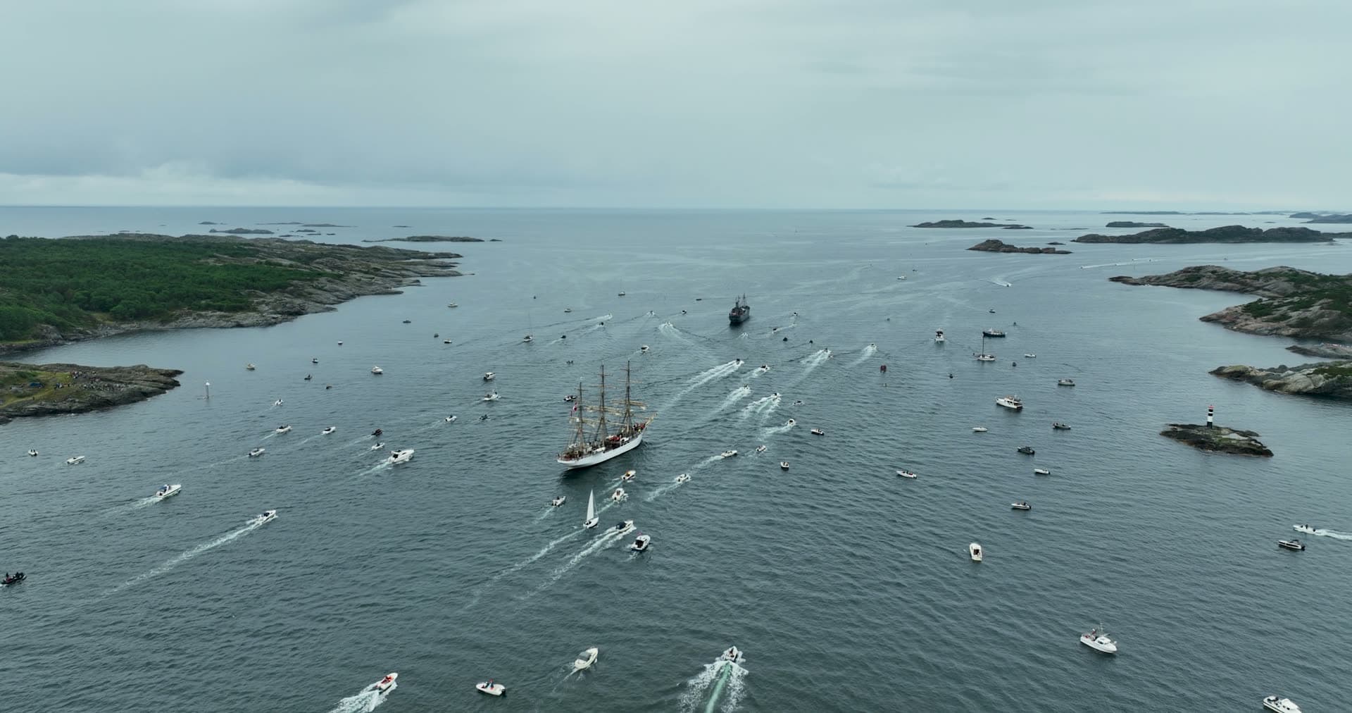 Traditional sailing vessel surrounded by recreational boat traffic, Kristiansand, Norway
