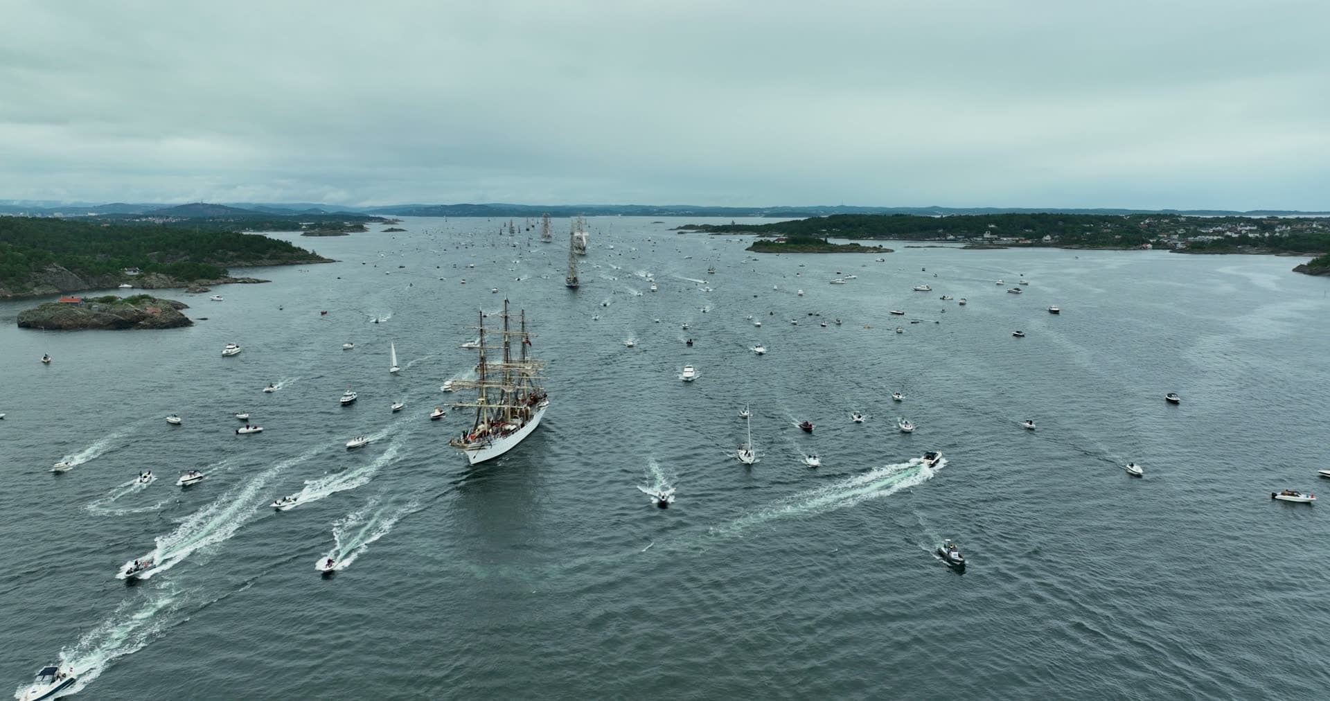 Tall ship leading motorboat escort parade, Kristiansand, Norway